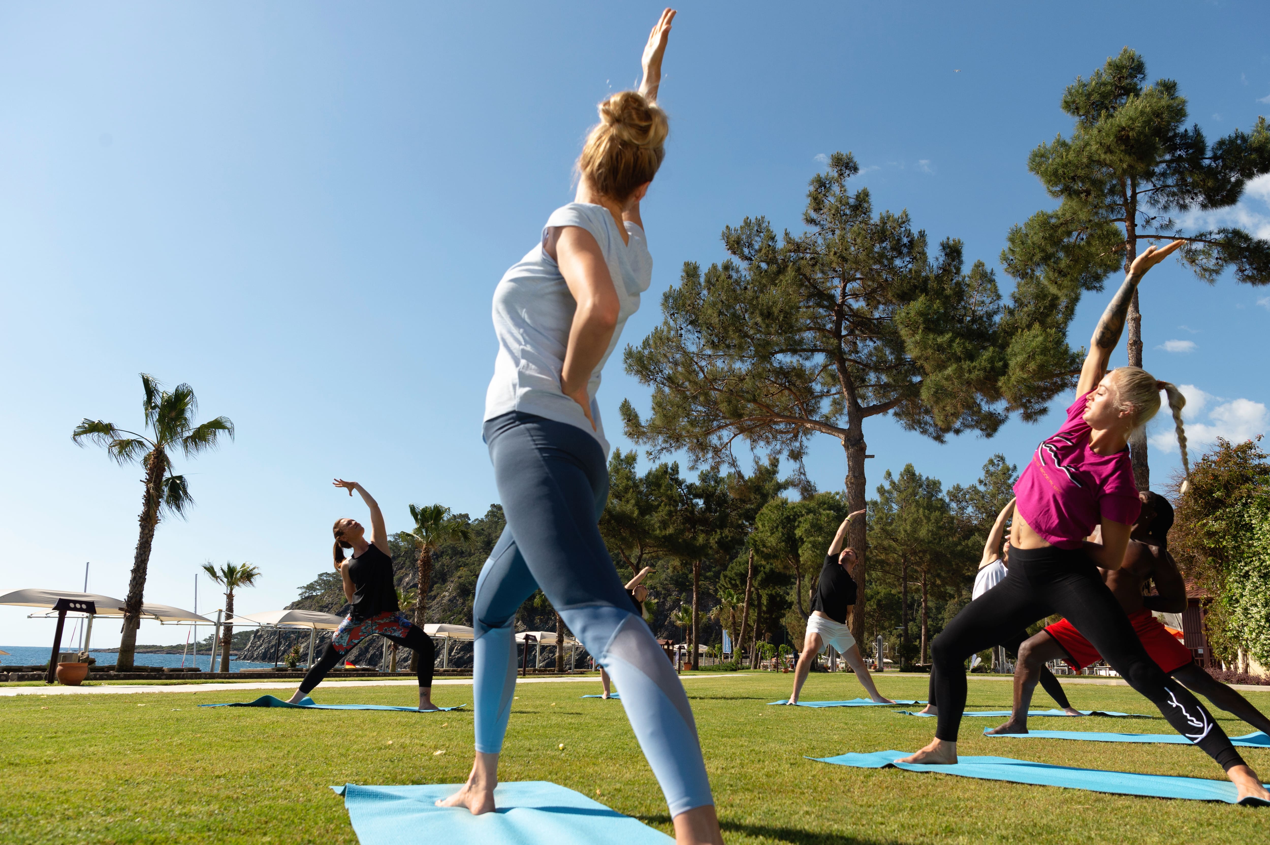 People doing yoga outdoors.