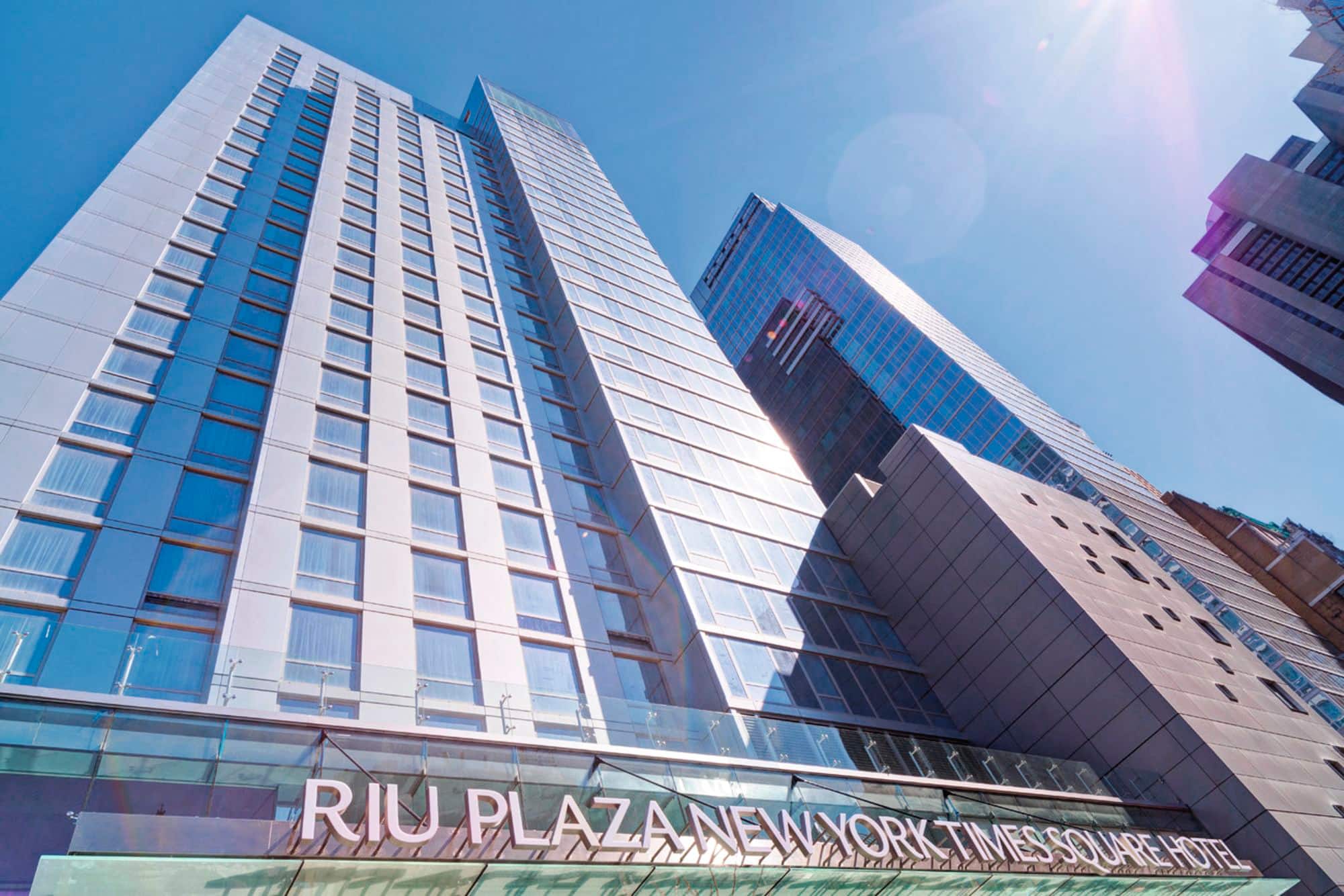 Low-angle view of the RIU Plaza New York Times Square hotel.