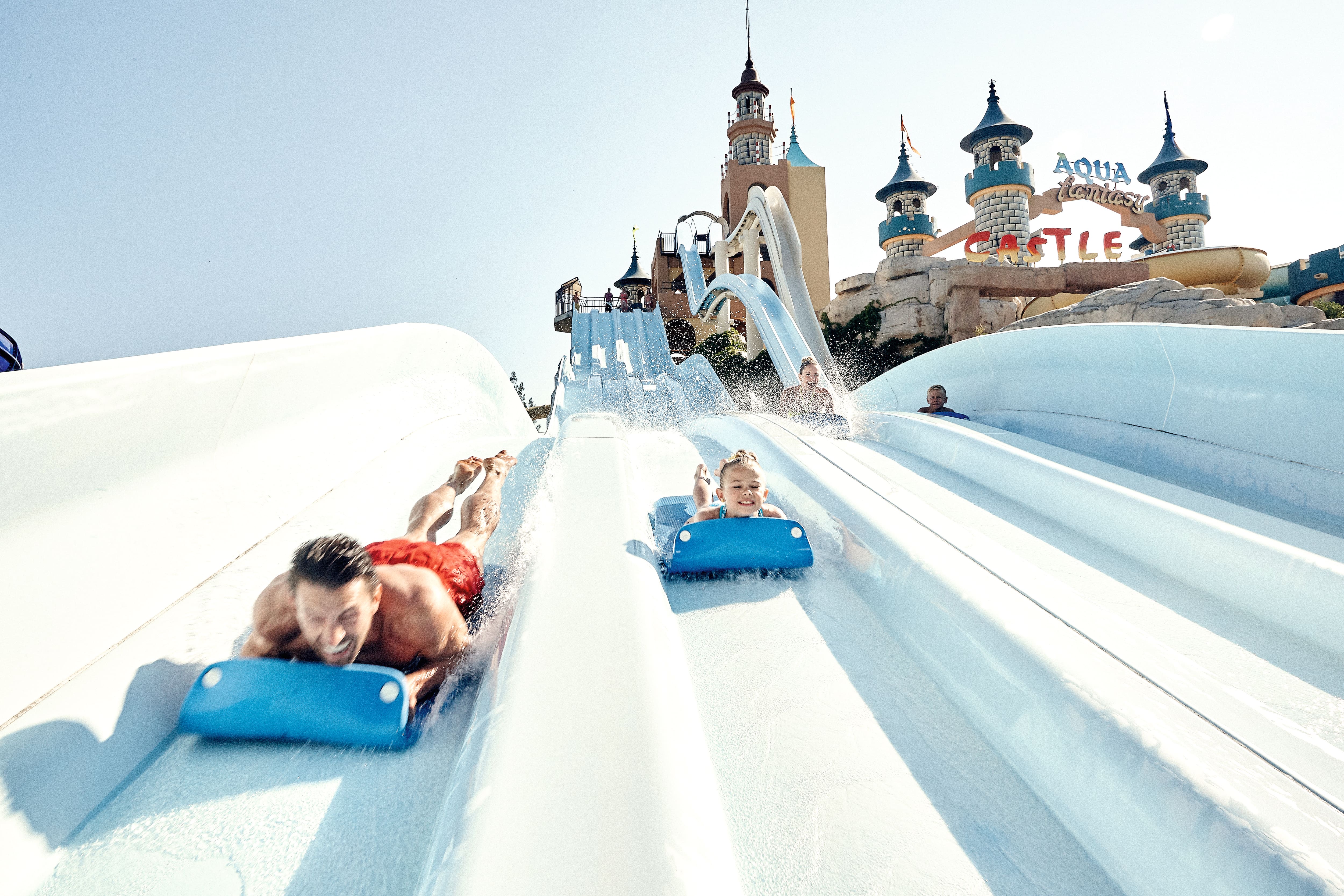 Adult and children riding the waterslides.
