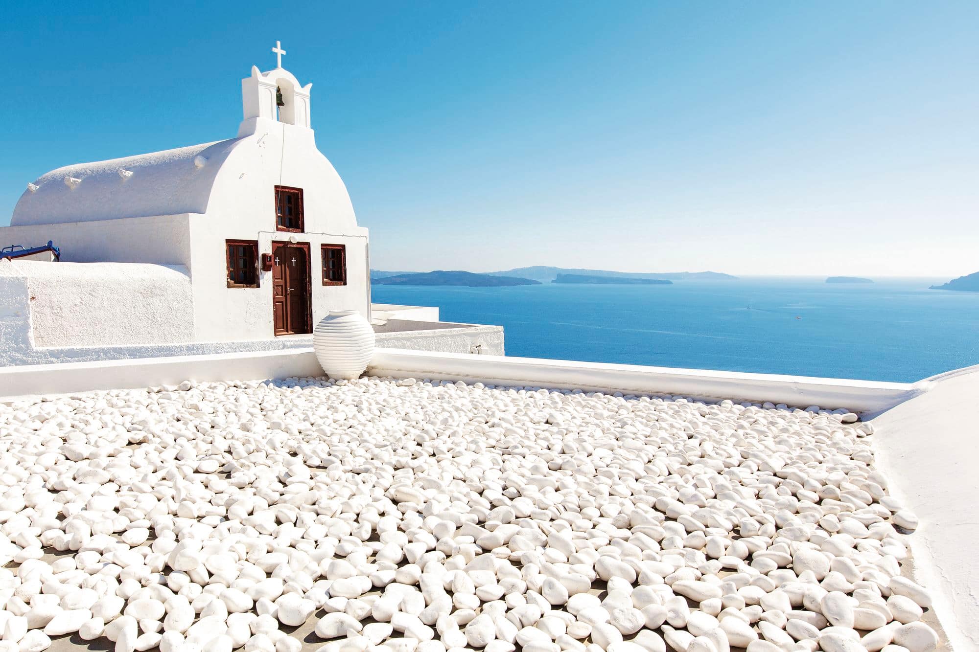 A white-washed church overlooks the sea in Santorini.