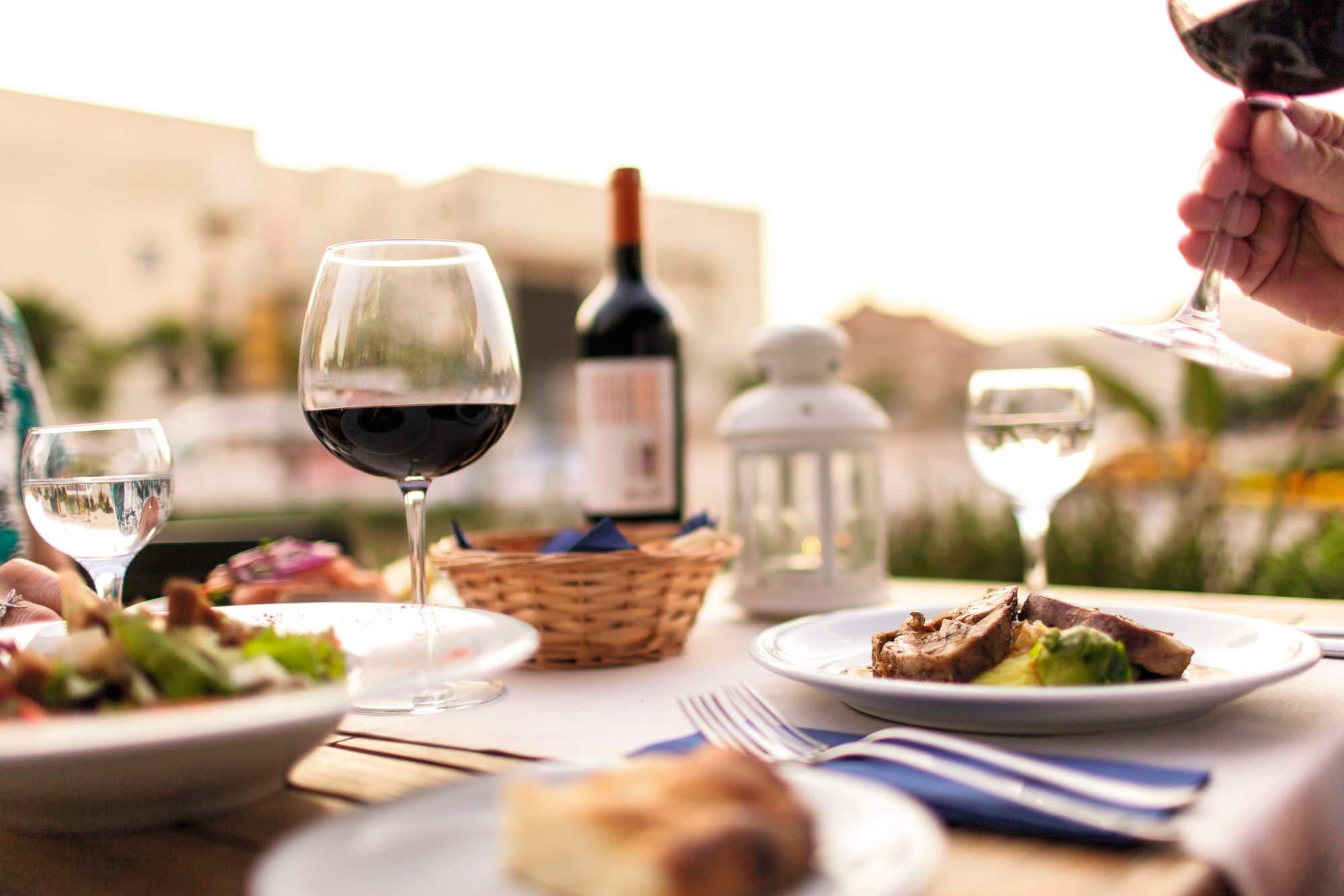 Food and wine arranged on a dining table.