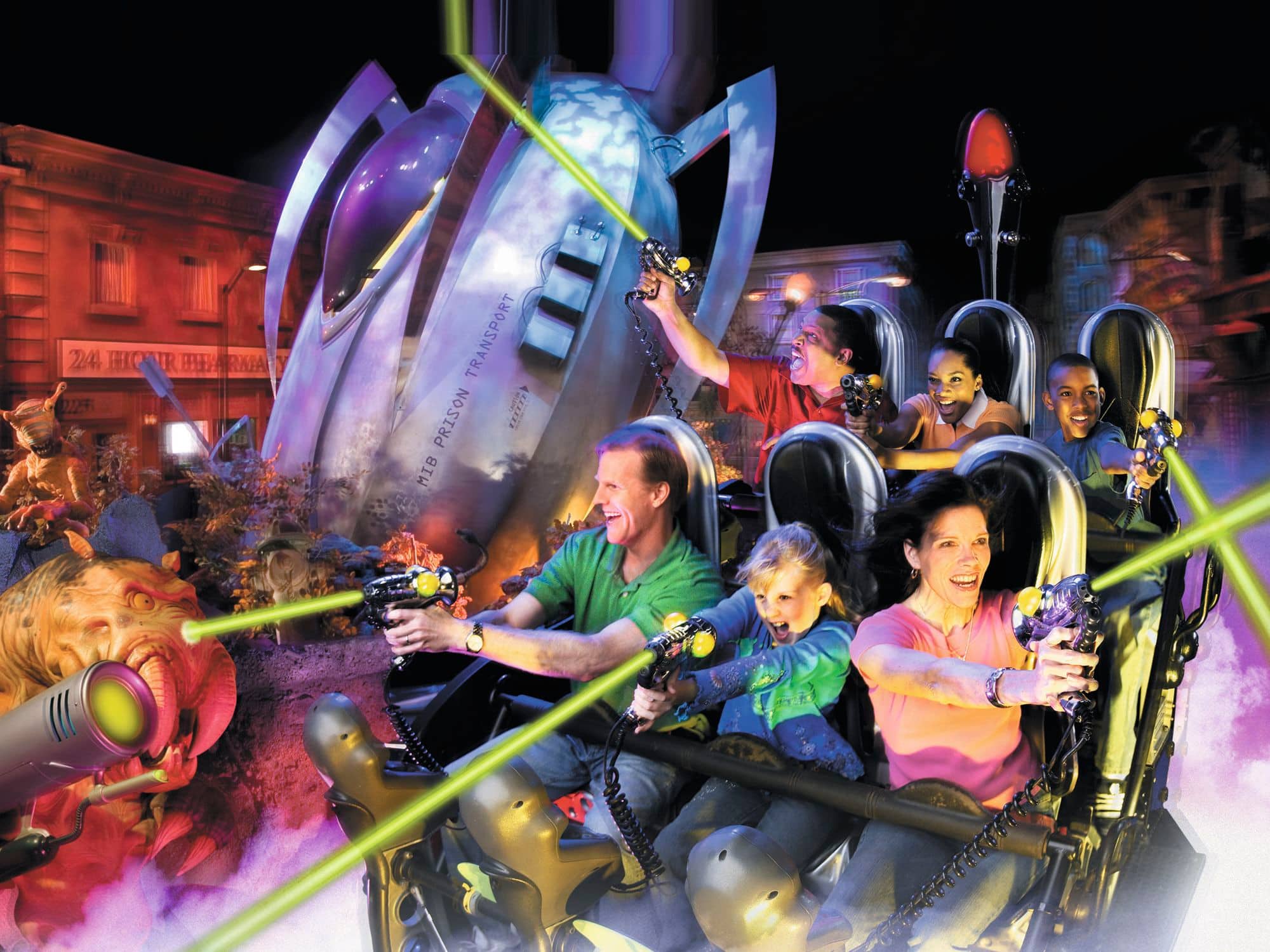 Passengers on an indoor laser tag sci-fi ride shoot at aliens.