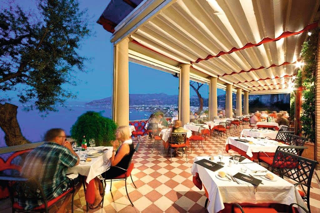 An al fresco dining area with a sea view.