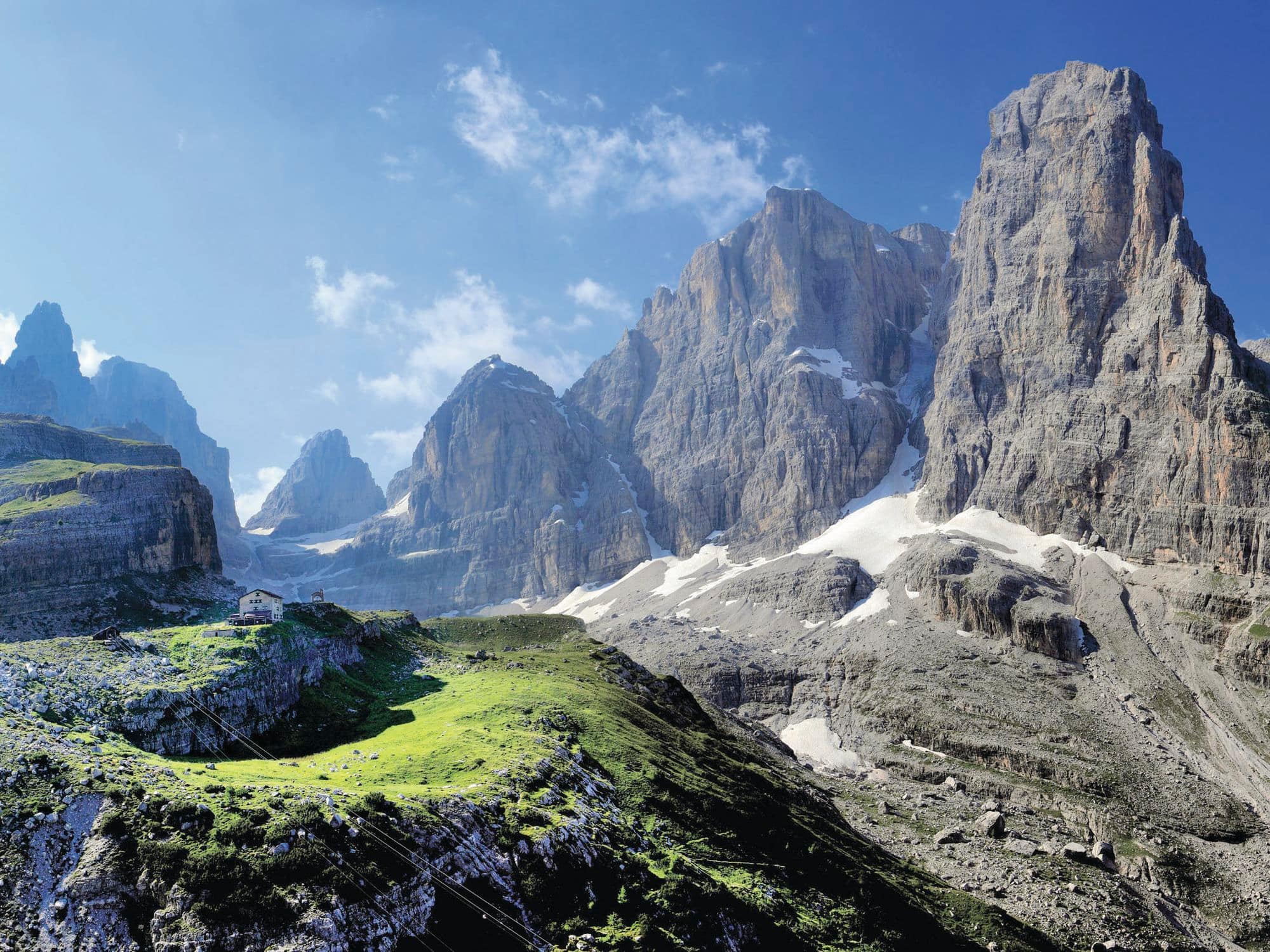 Slate grey jagged mountains and spots of greenery.