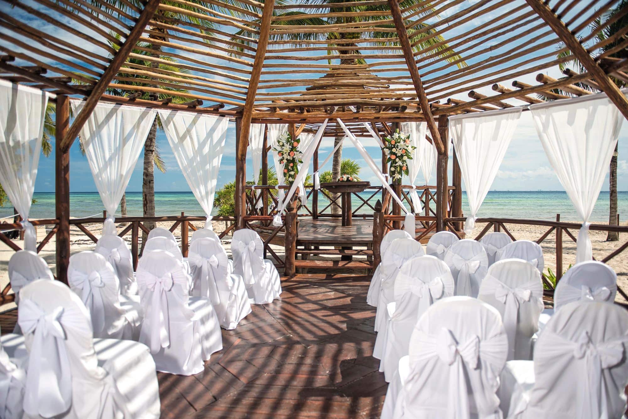 A wedding ceremony set up on a beach.