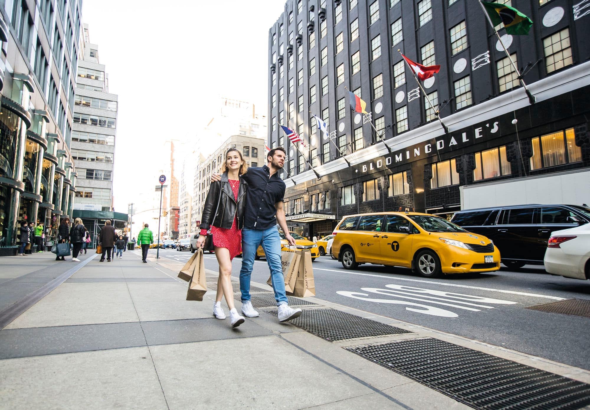 A couple walking past Bloomingdale's in New York.