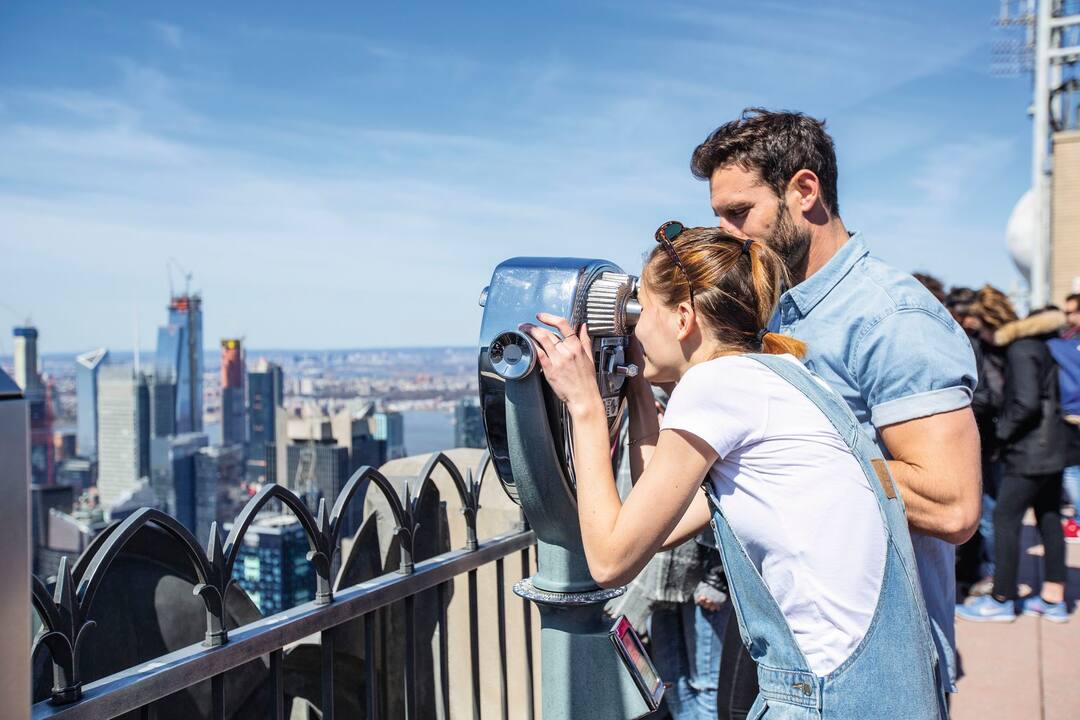 Couple looking out over New York City from the Empire State Building