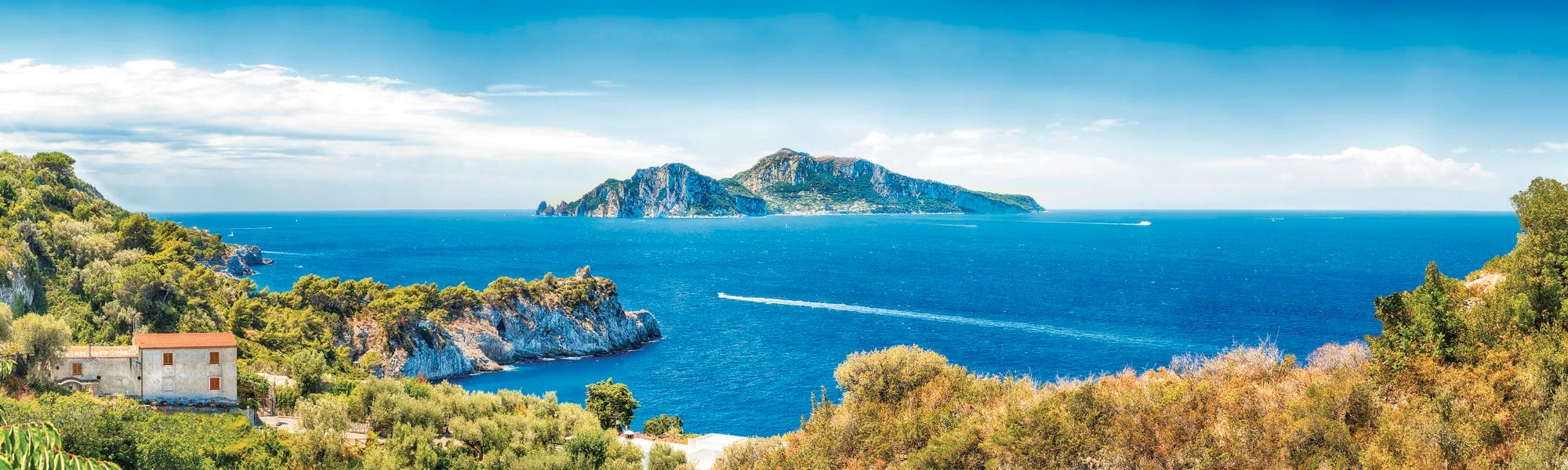 A view of a rocky island off a coastline.