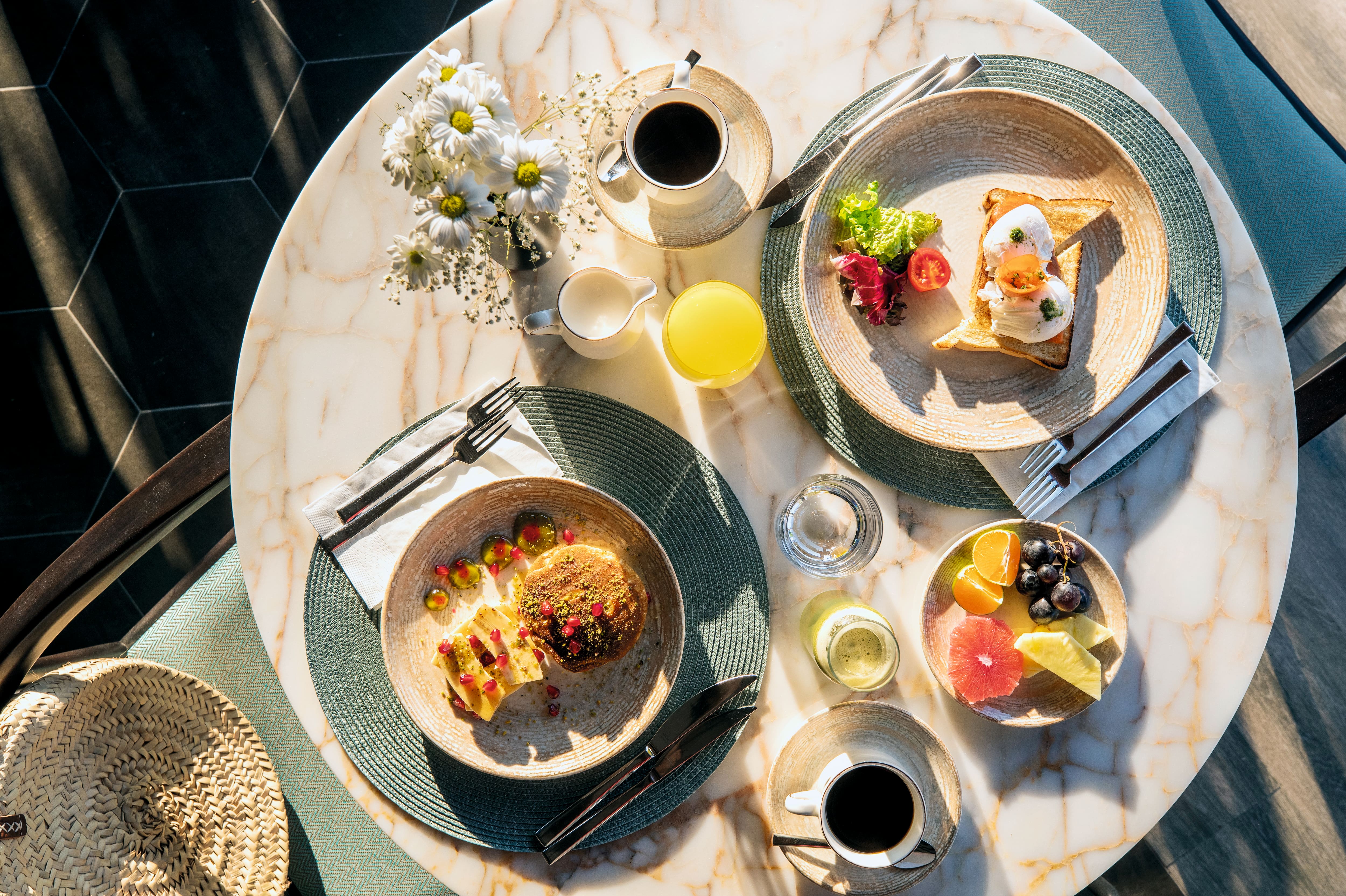 Overhead view of food arranged on a round table.