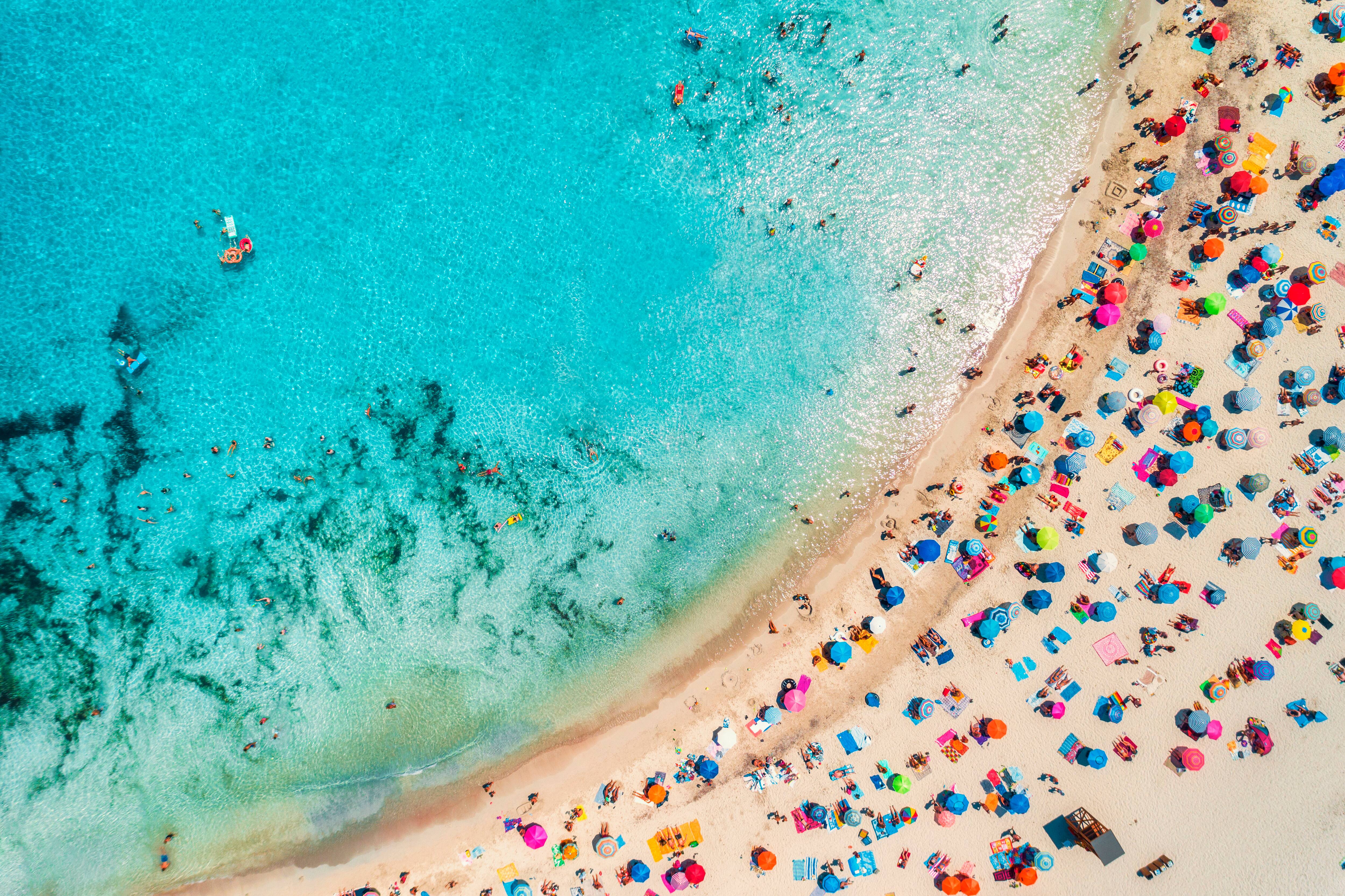 A view of the sun loungers and parasols on a beach, and then blue sky.