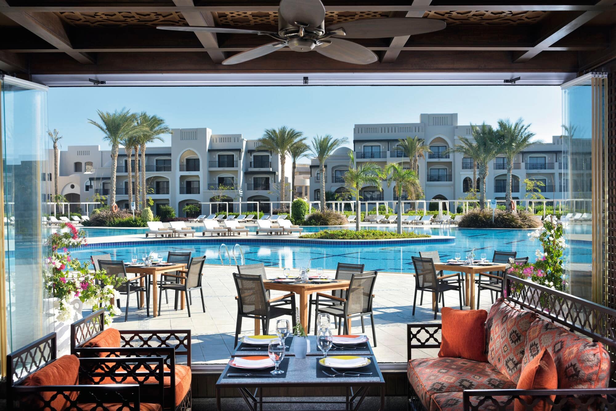 A view of a restaurant table looking out to the pool at TUI Blue Samaya.