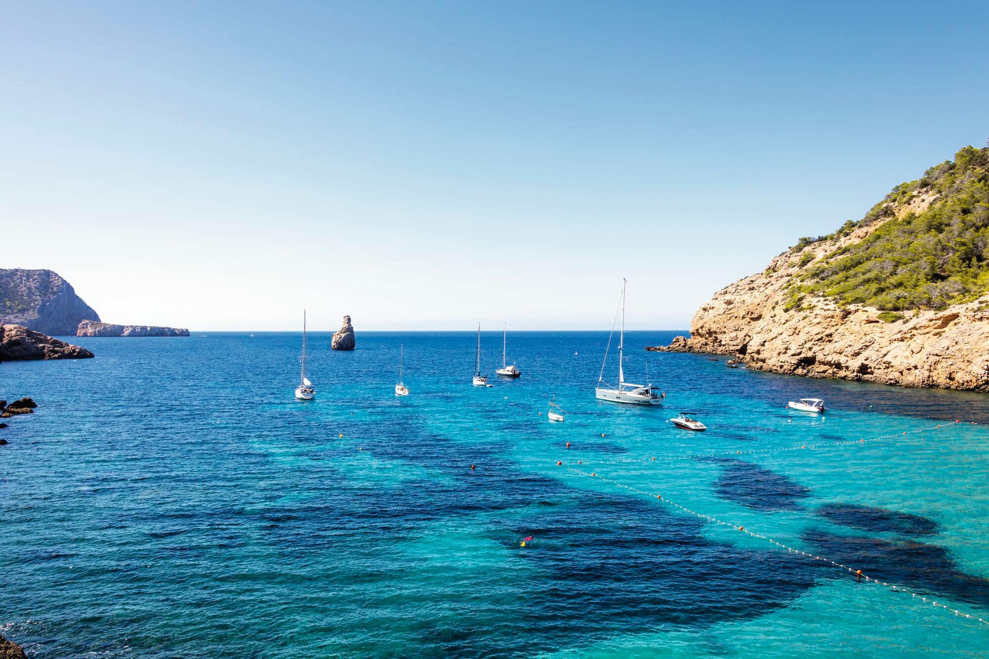 Small yachts by the Ibiza coastline.