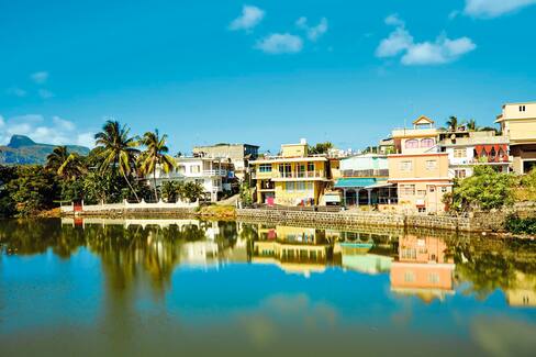 River and reflected buildings, Mahebourg