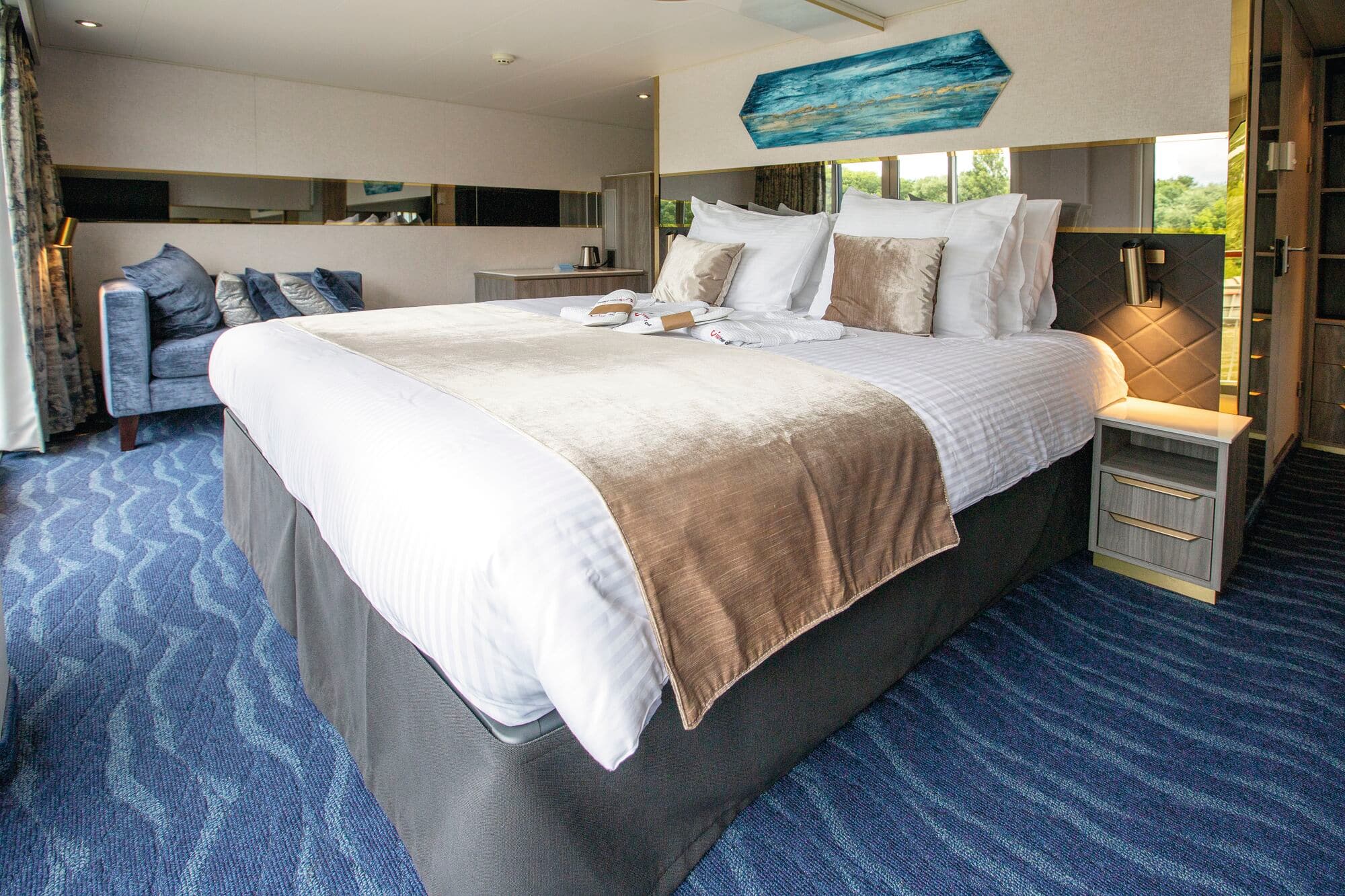 A balcony cruise cabin with a double bed.