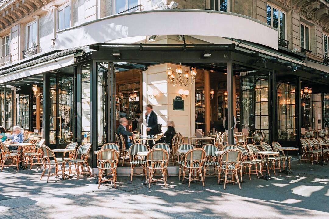 Typical view of the Parisian street with tables of brasserie in Paris, France