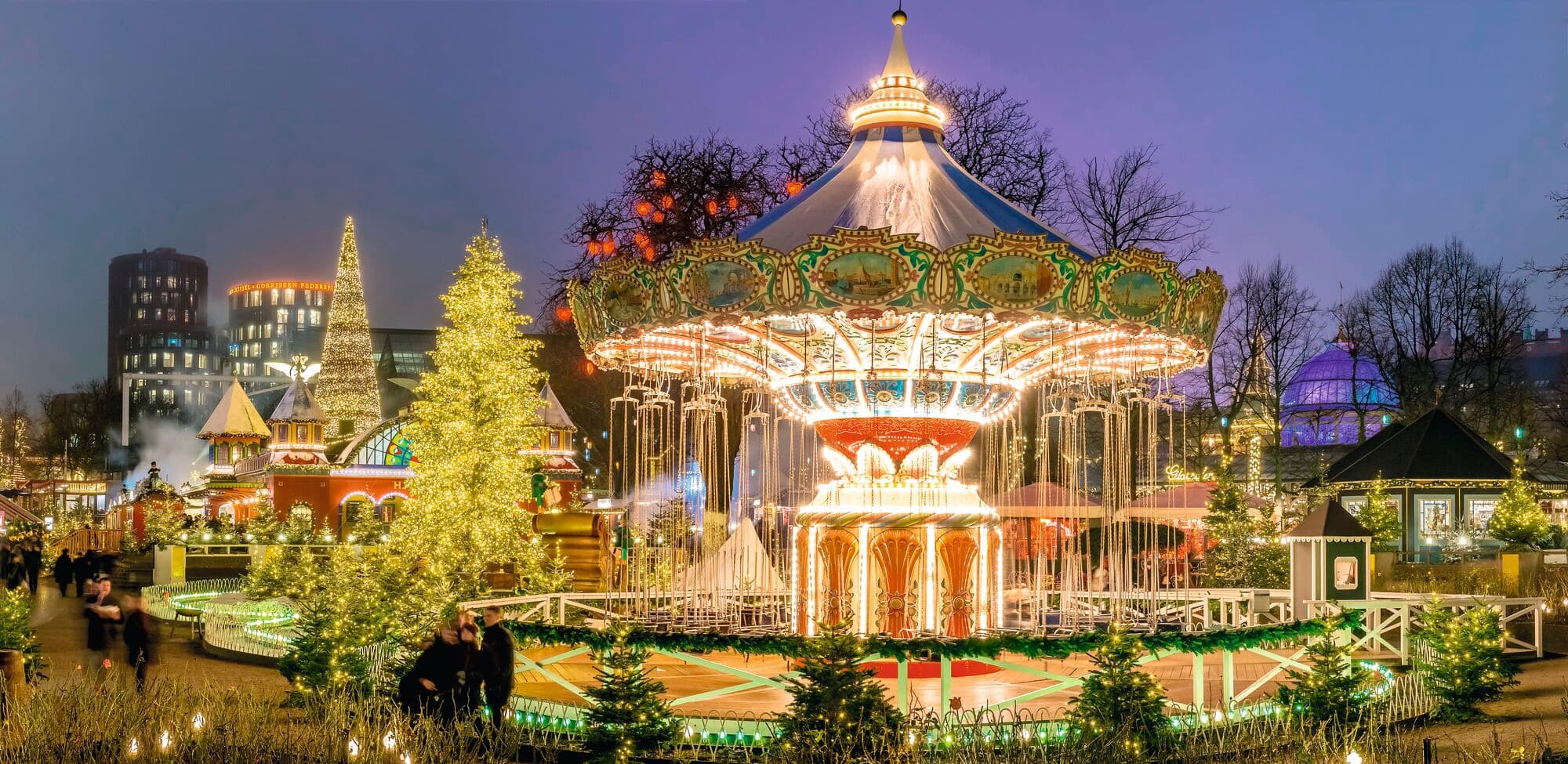 A carousel in the middle of a Christmas market.