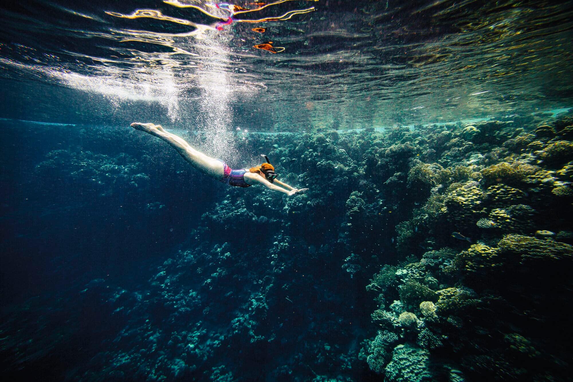 A woman diving underwater.