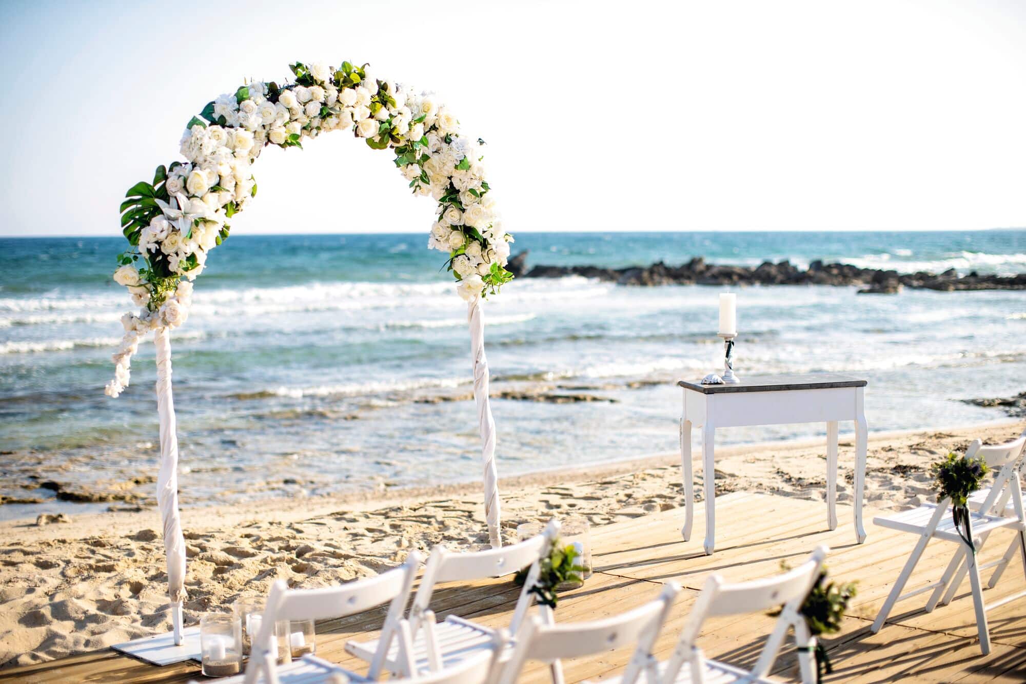A wedding ceremony set-up on a beach.
