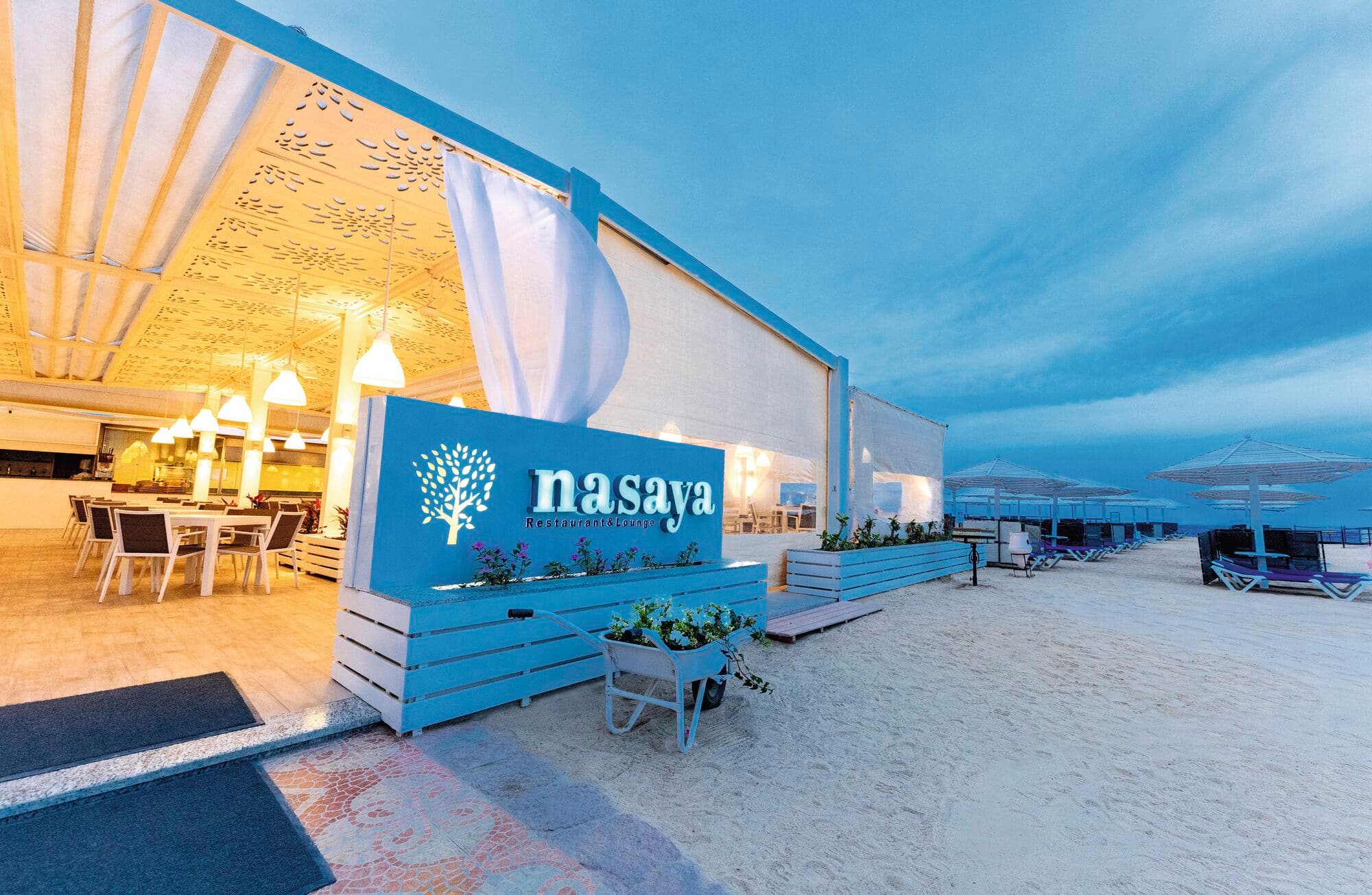 A beachfront hotel restaurant in the evening.