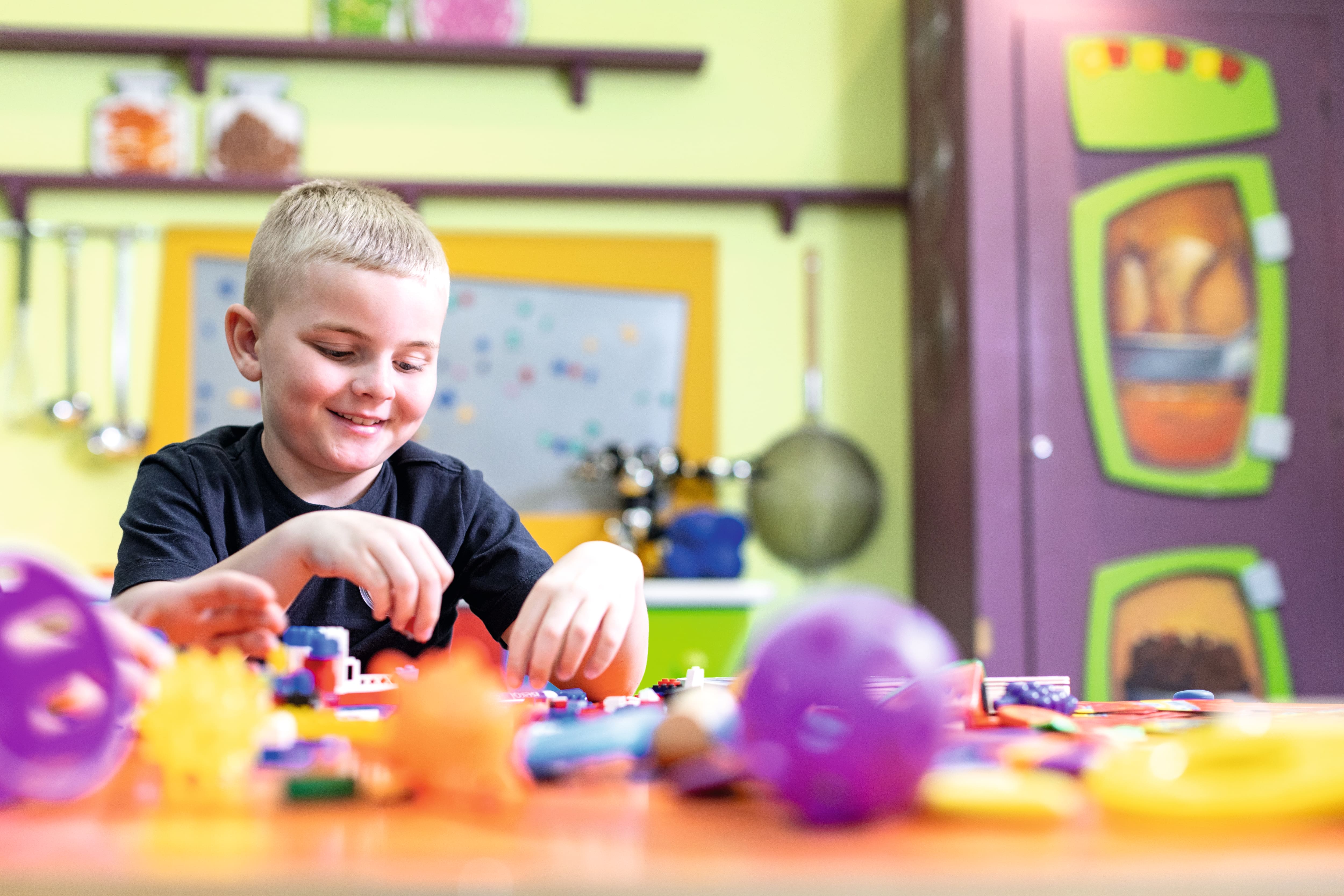 Little boy playing with toys.