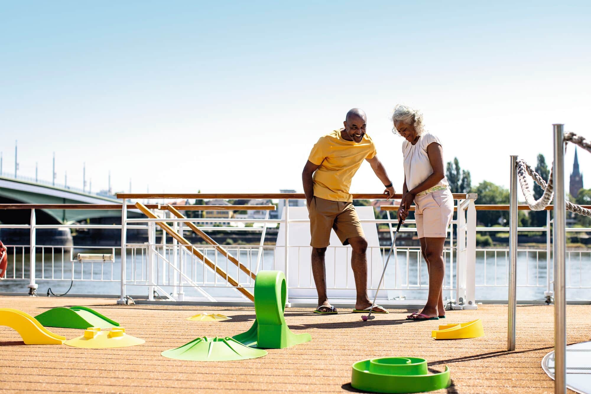A couple playing mini-golf.