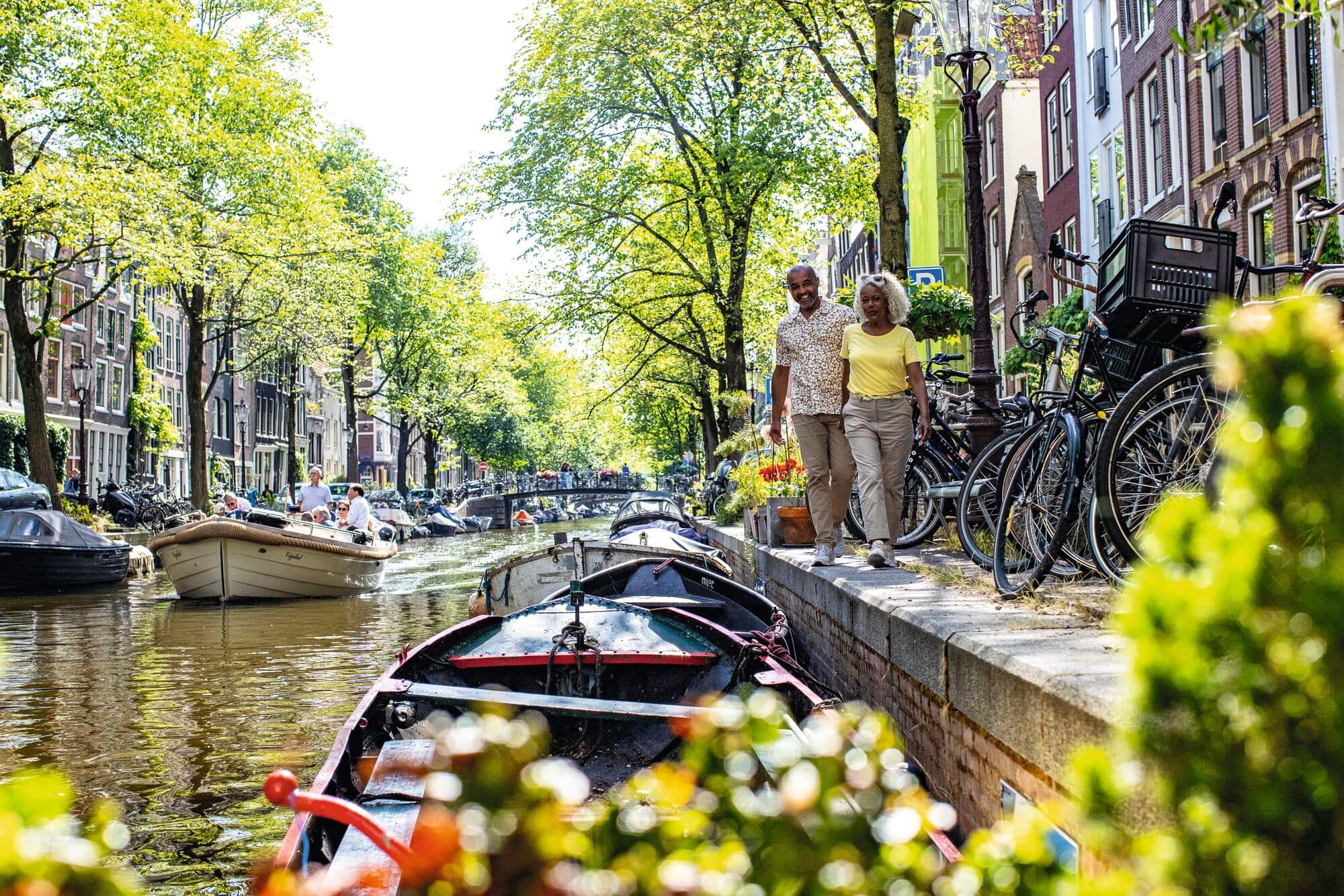 A couple walking down the canals in Amsterdam.