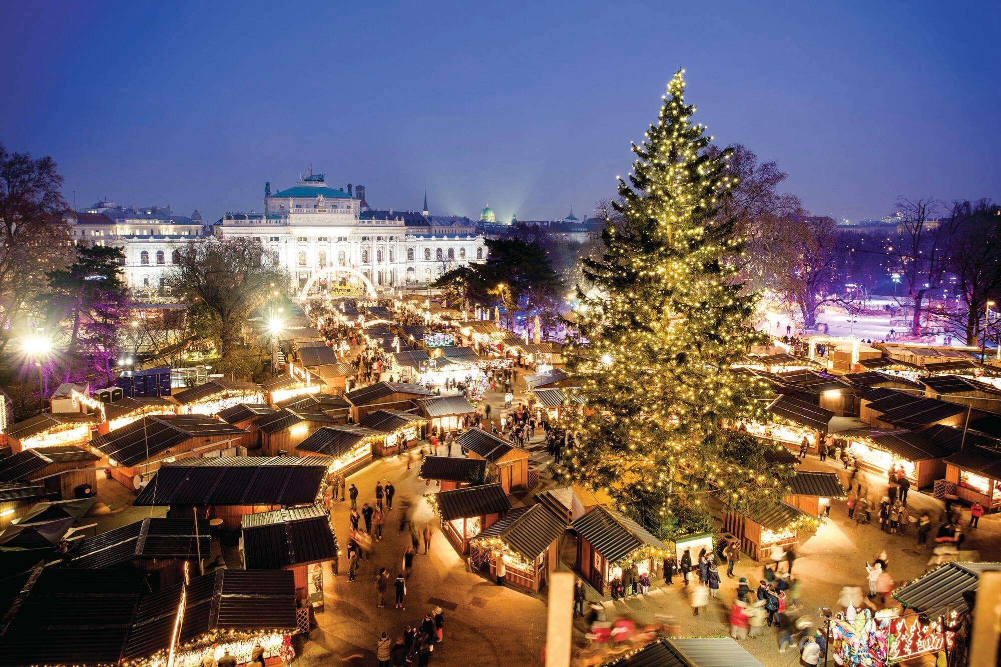 A big Christmas tree in the middle of an Austrian Christmas market.