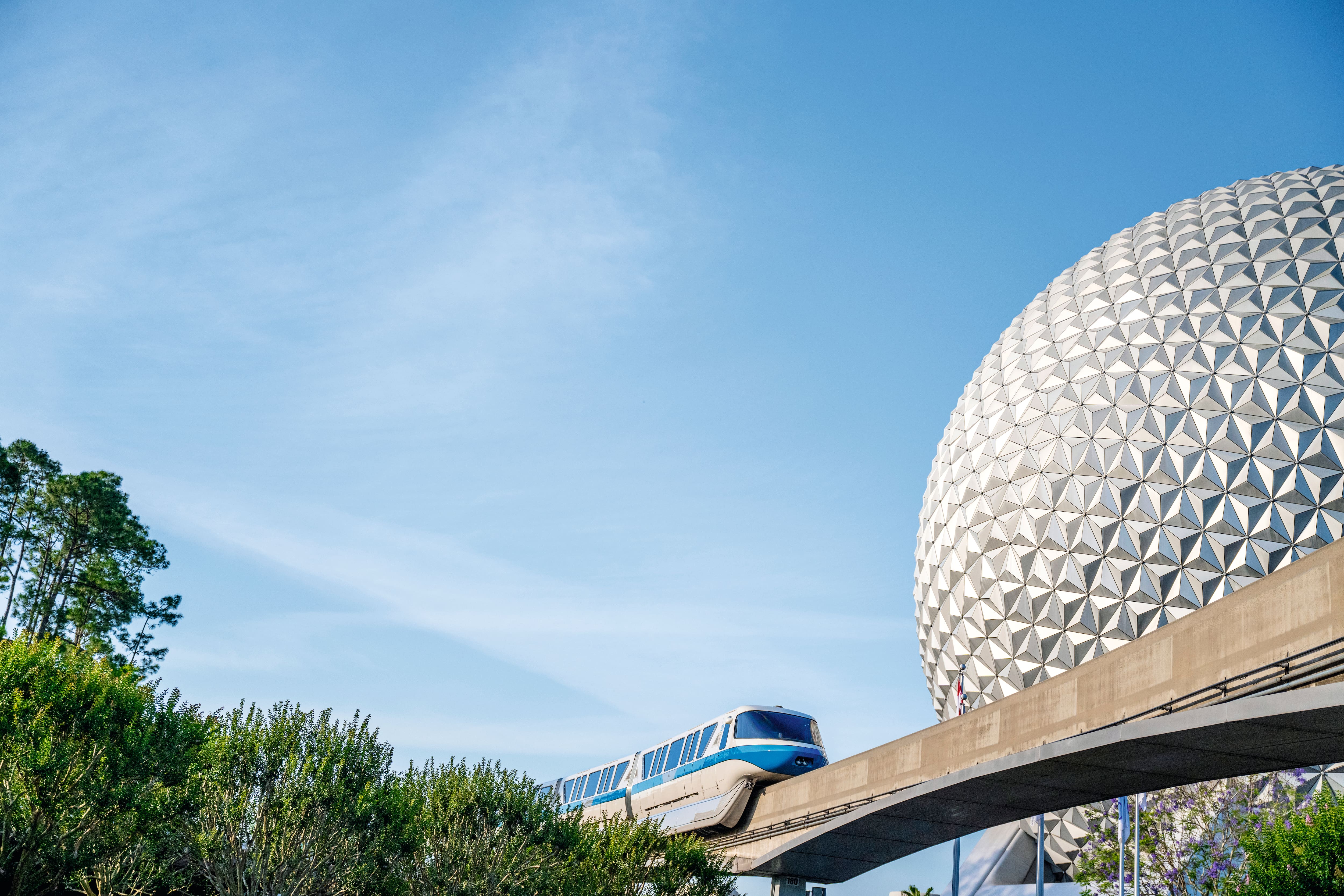 Epcot golf ball to the right, with monorail pass by.