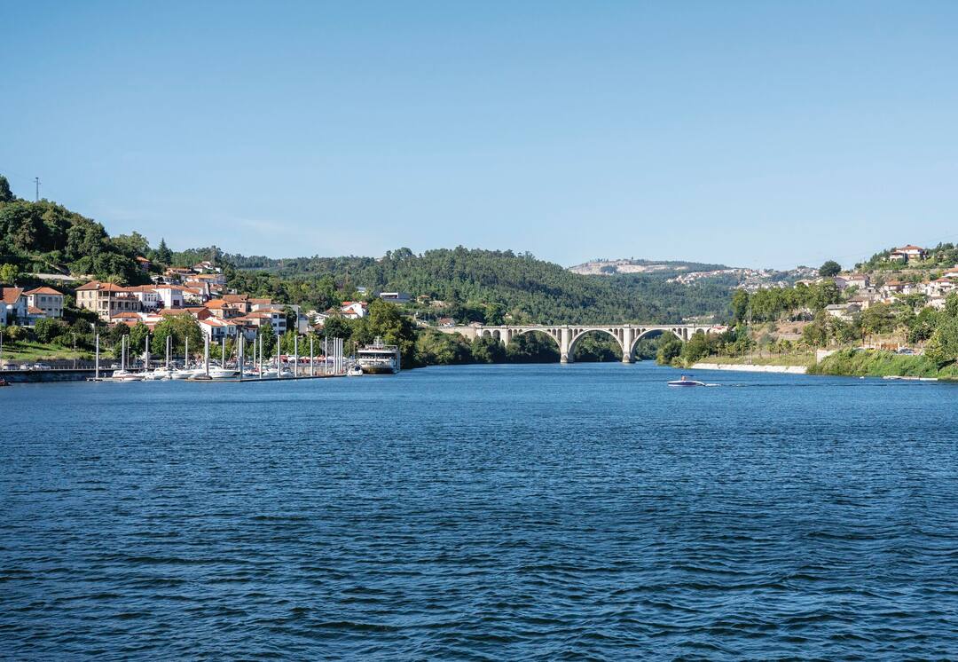 Small marina with power boats and docked river cruise boat in the Douro valley, Portugal
