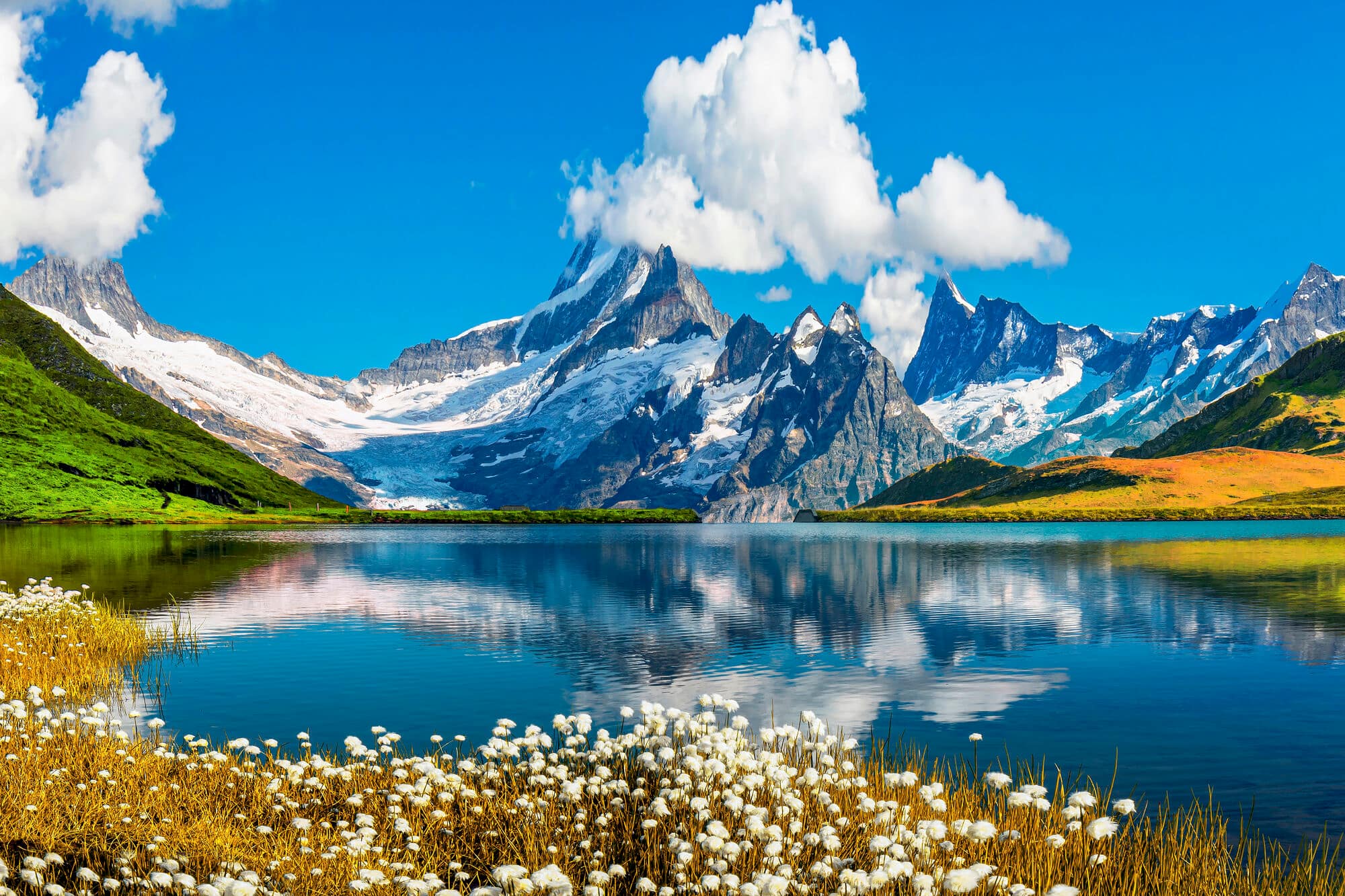 A view over the Bernese mountain range above the clear blue Bachalpsee lake.