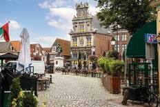Roode Steen square with ancient Town hall and statue of Jan Pieterszoon Coen