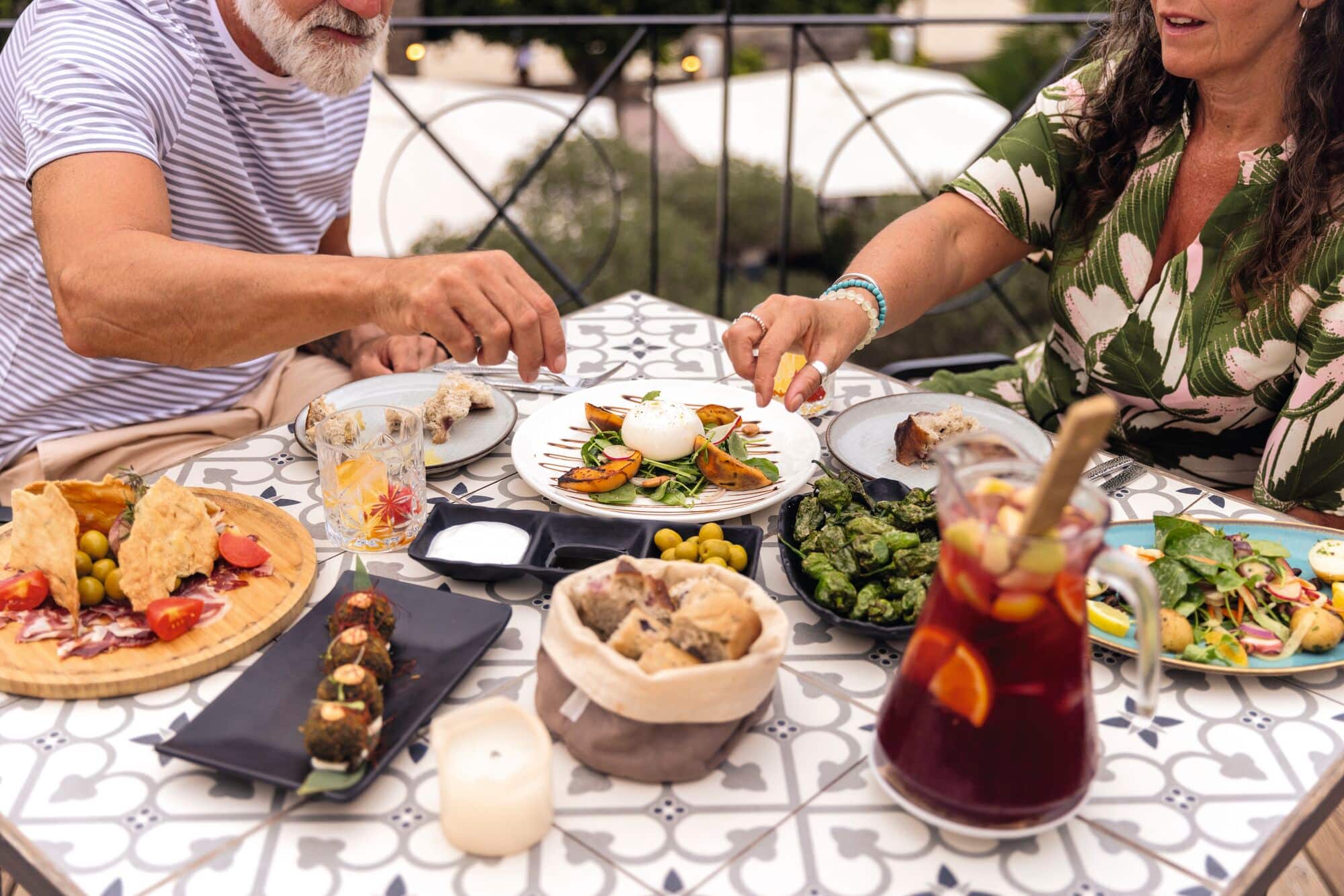 A table arranged with a variety of tapas dishes.