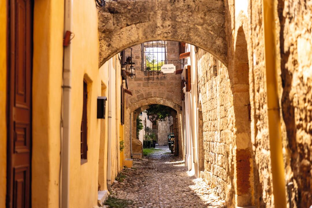 Strolling through alleys in the Old Town Harbour, Rhodes