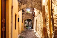 Strolling through alleys in the Old Town Harbour, Rhodes