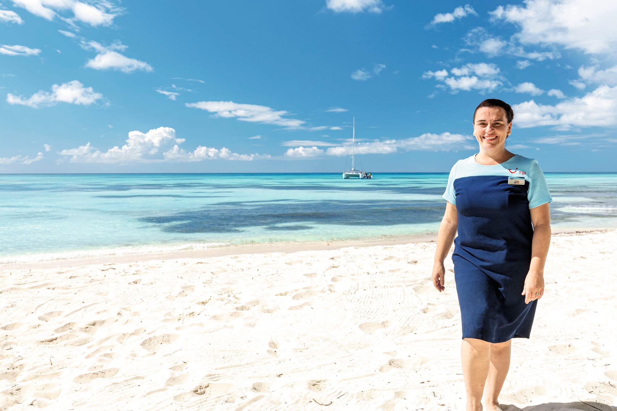 A TUI colleague walking along a beach in the Dominican Republic.