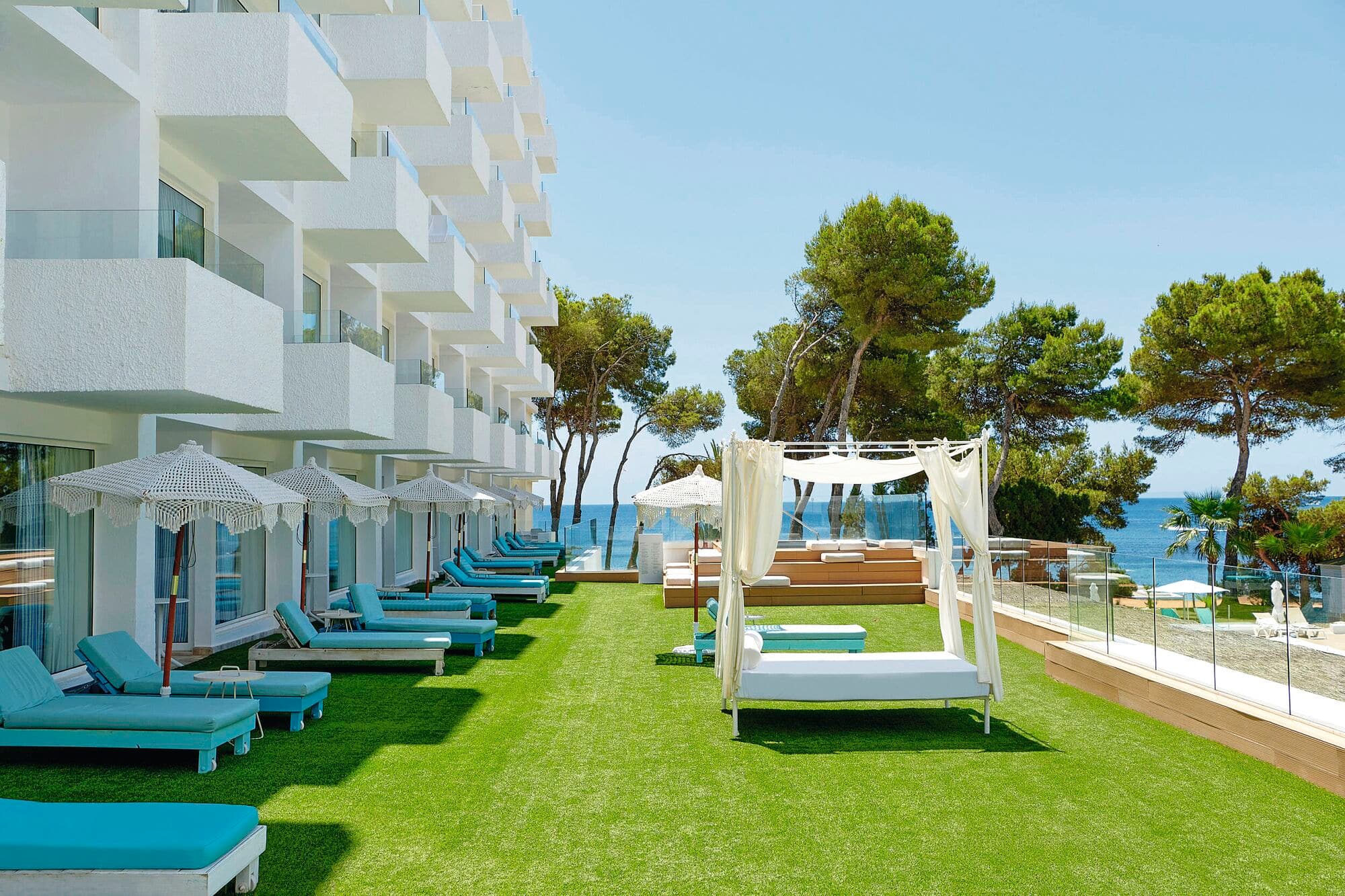 Terrace area with sun beds and cabanas.