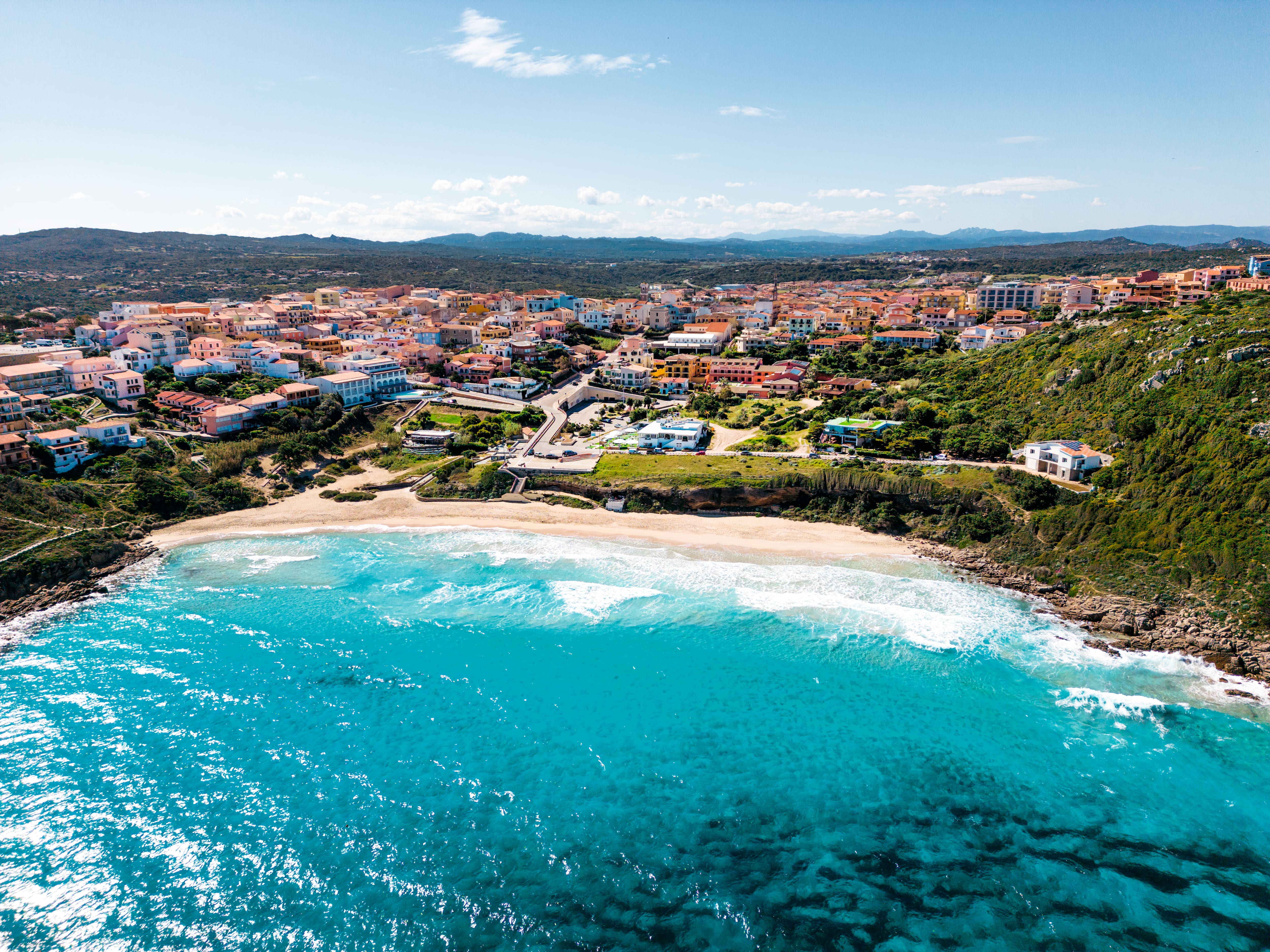 An aerial view of a colourful coastal town near the sea in Italy.