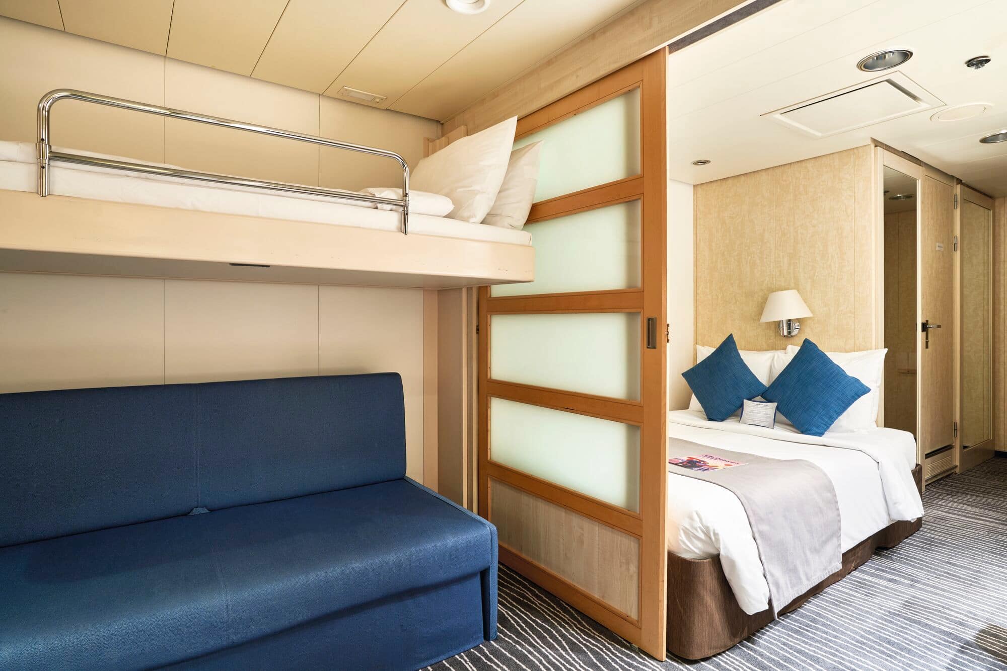 A family cabin with sofa-bed and bunk bed.