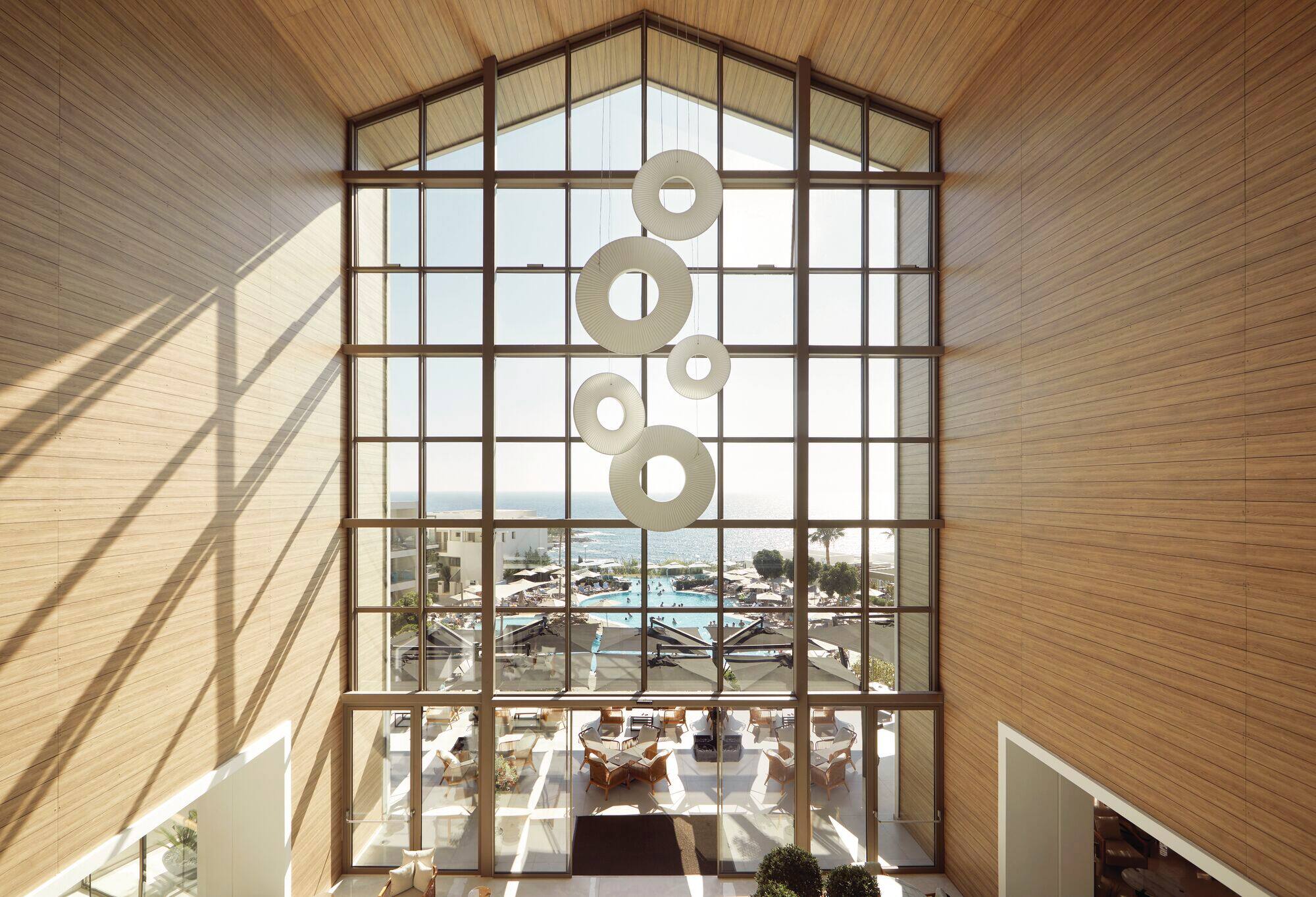 A lobby floor-to-ceiling window with a view of the pool.
