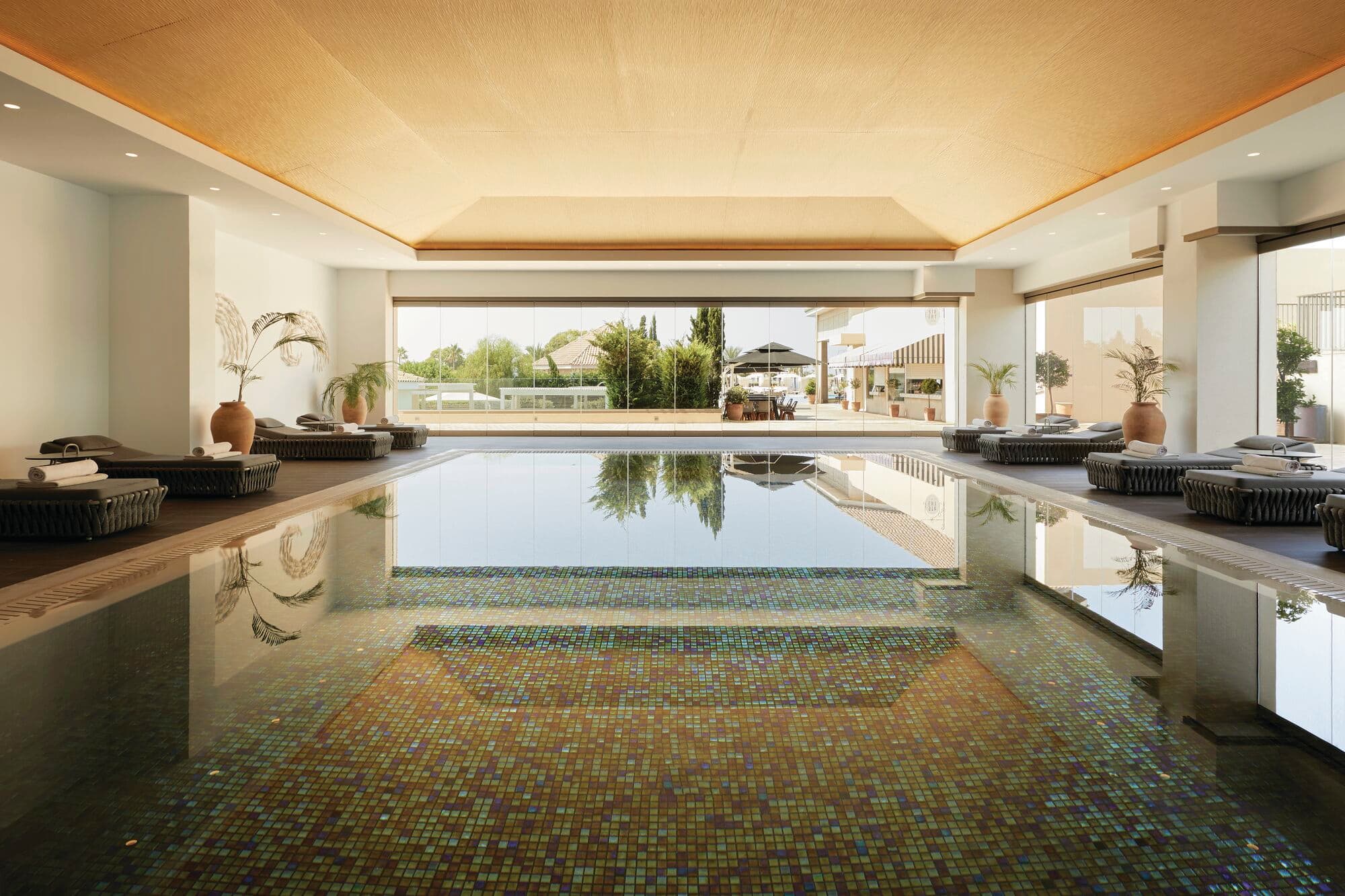An indoor spa pool with daybeds.