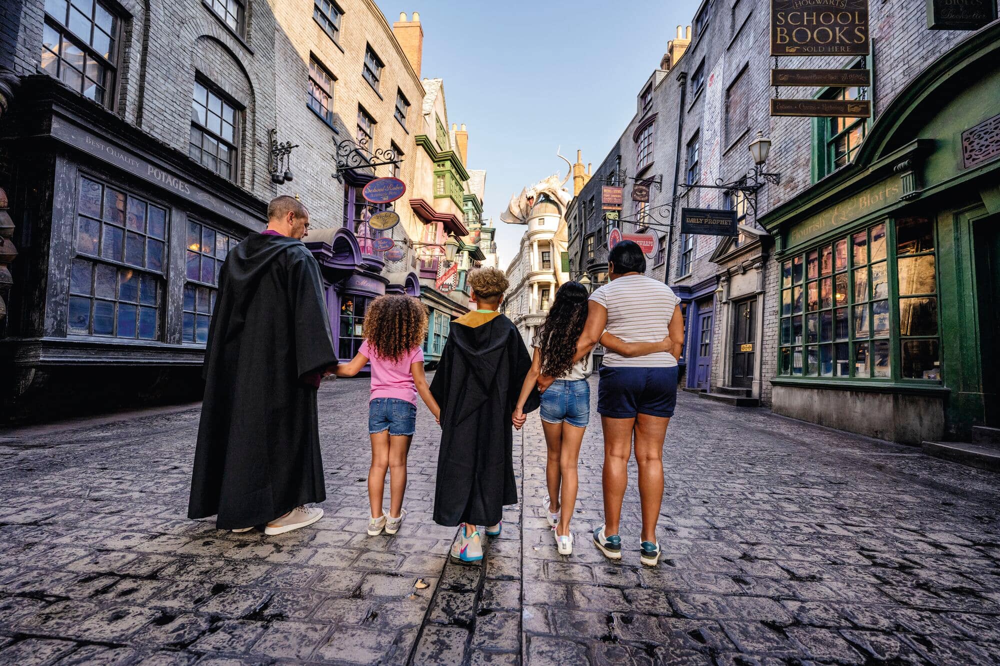 A family walk through Knockturn Alley within the Harry Potter section of Universal Studios Orlando.