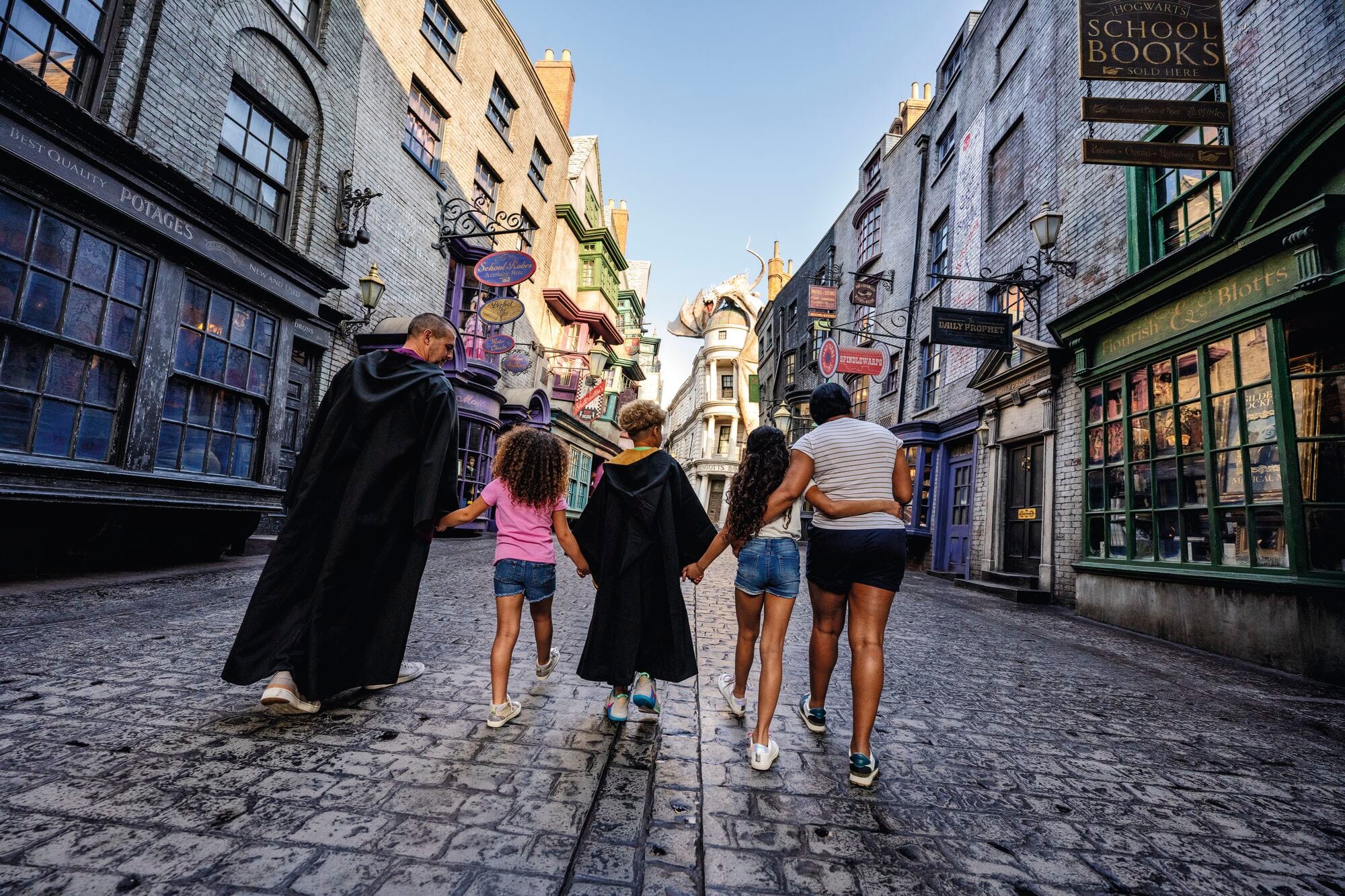 A family walking down Diagon Alley.