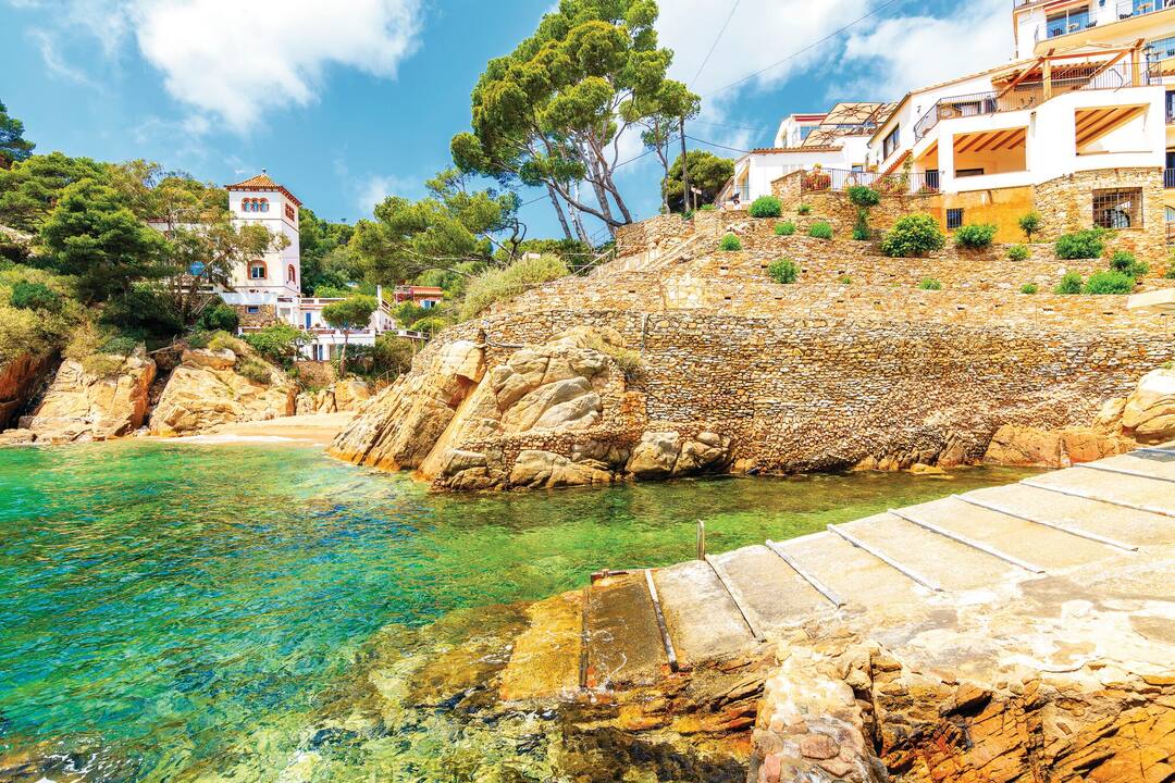 Small beach in port of Cala Fornells fishing village, Costa Brava, Catalonia