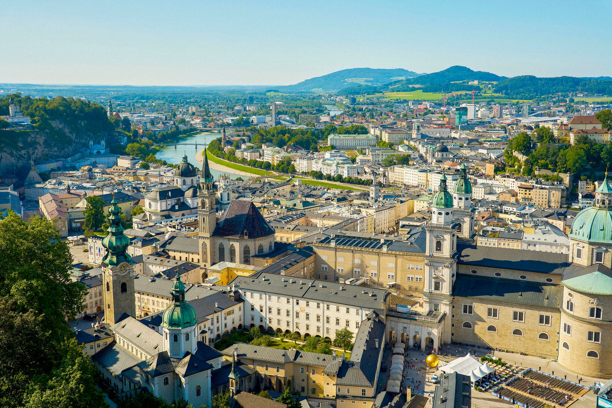 Aerial view of Salzburg city. The river Salzach flows through the middle and sun is shining. 