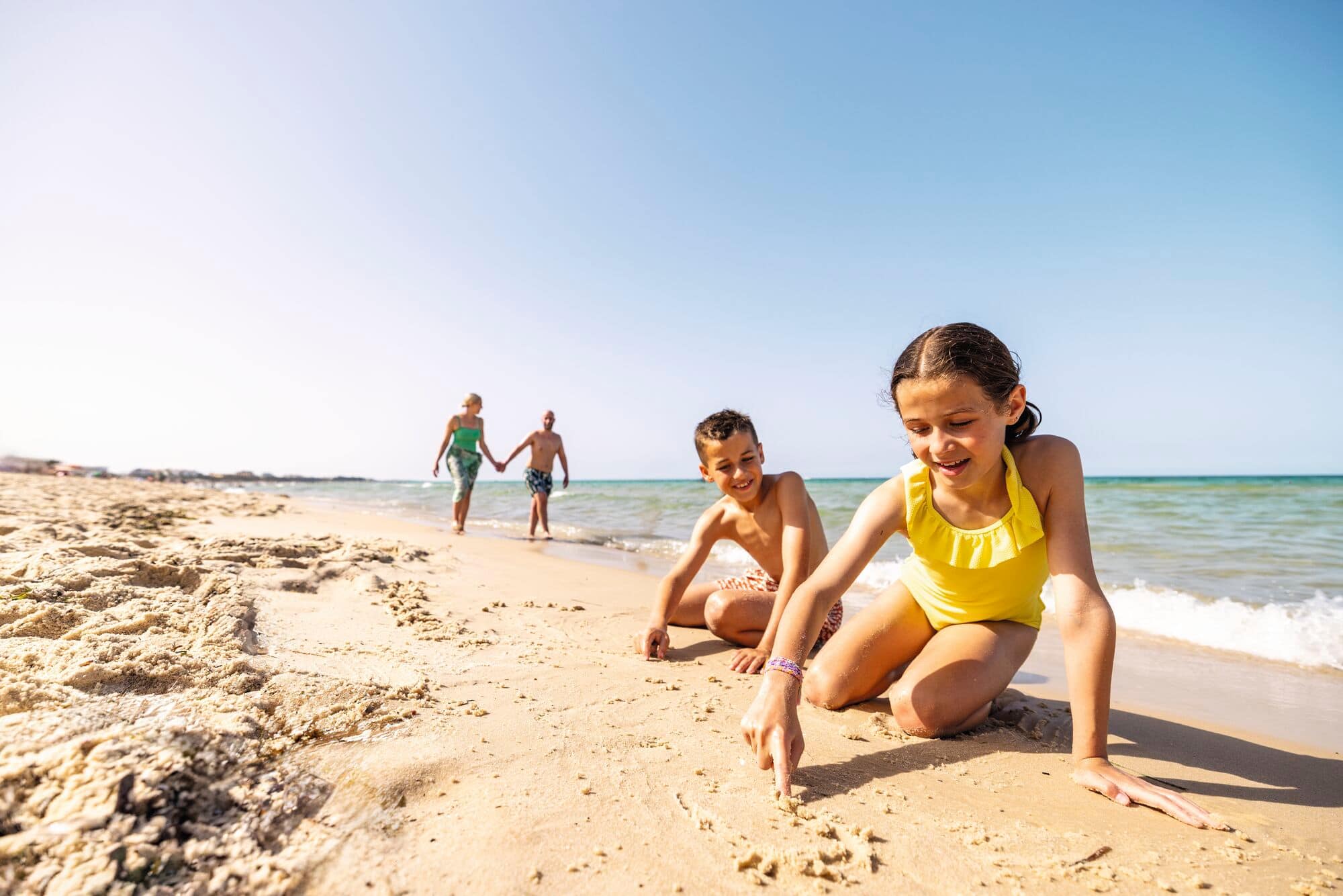 Two children building a sand castle