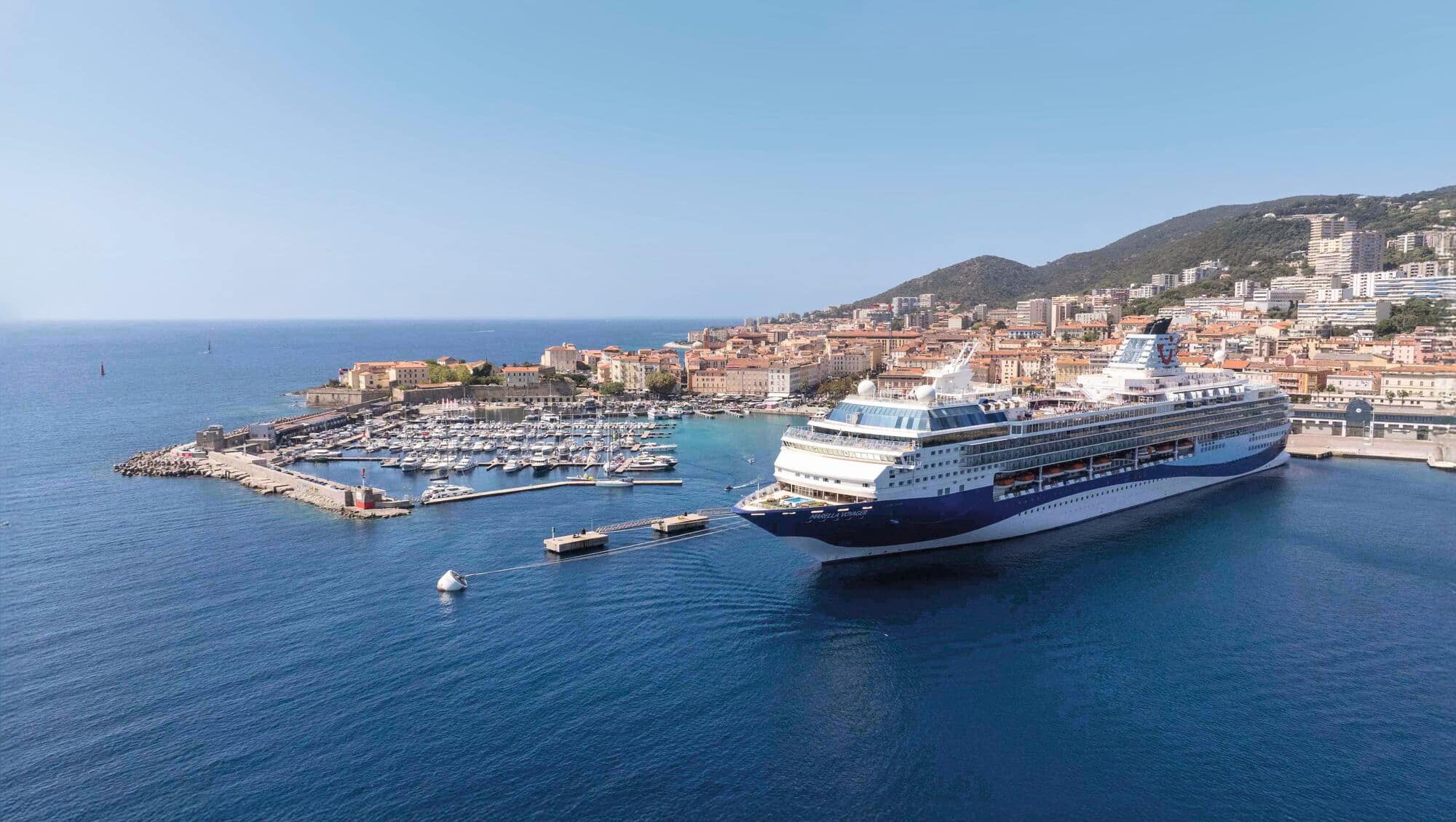An aerial view of the Marella Voyager in a sunny harbour.