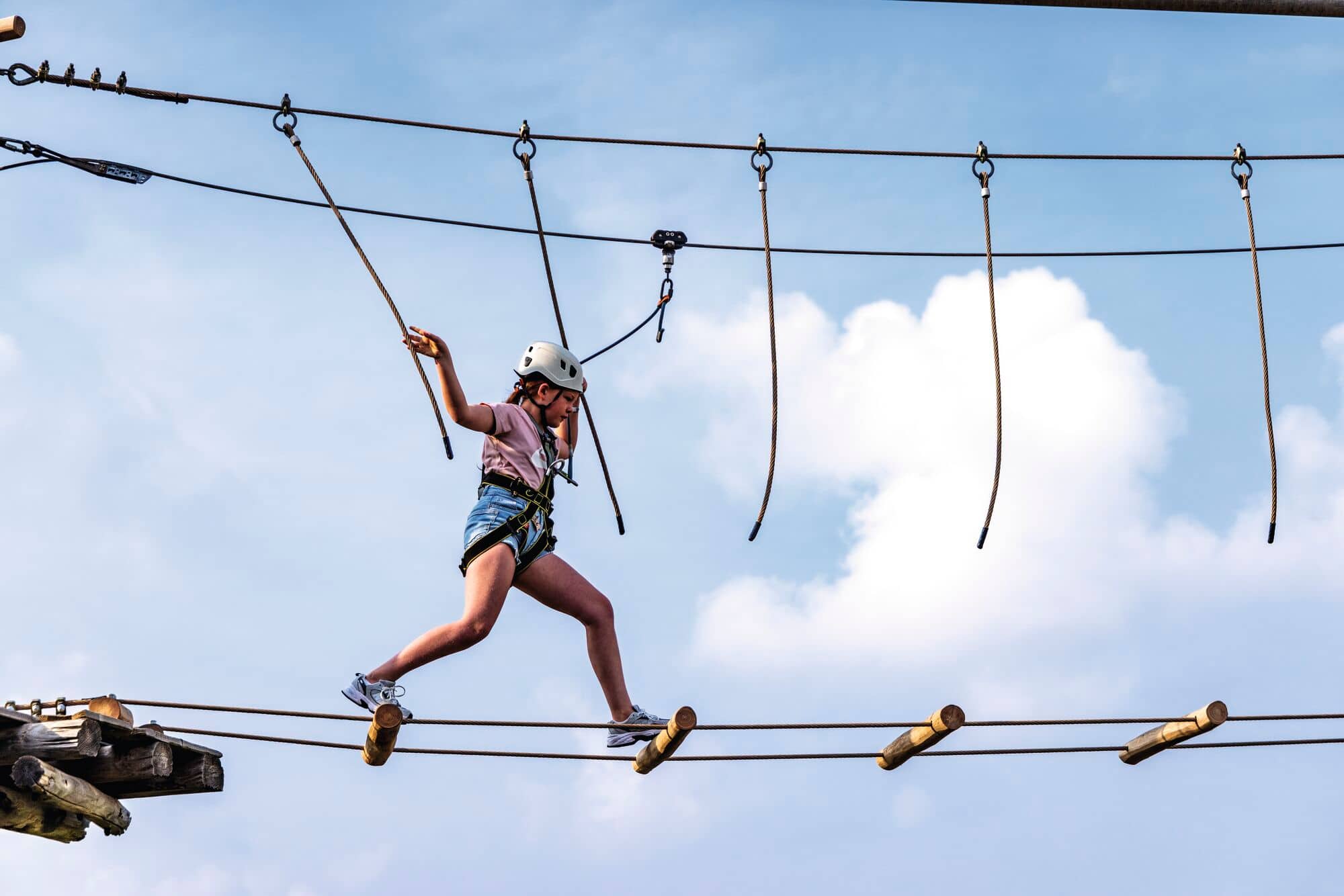 A child on an aerial adventure course.