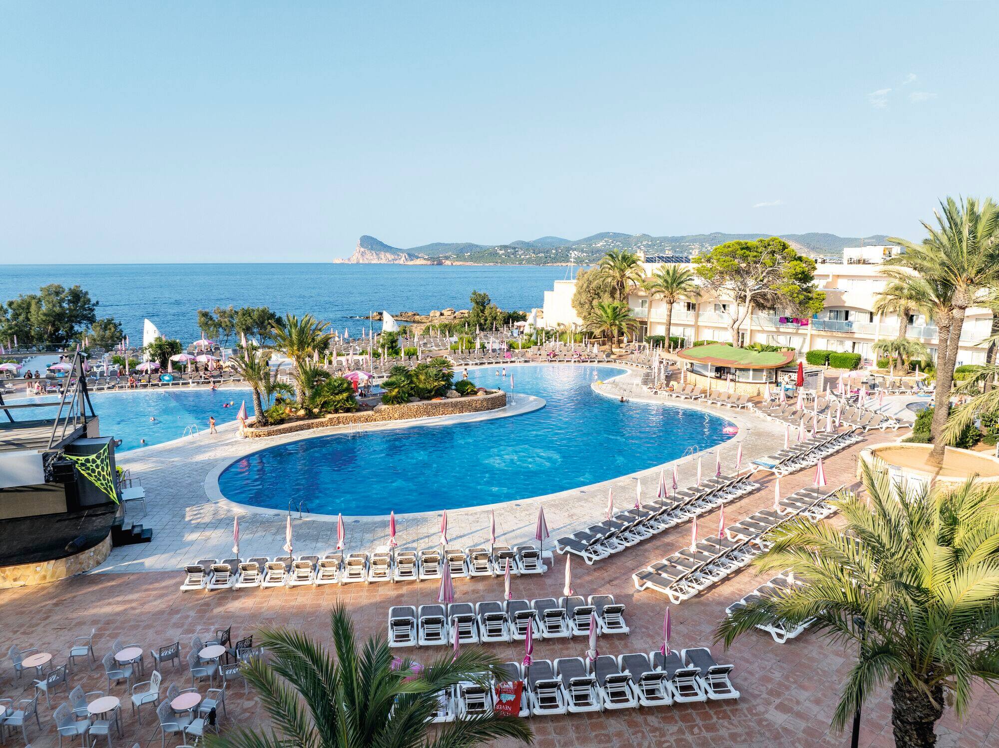 A view of hotel pool with mountainous landscape in the background
