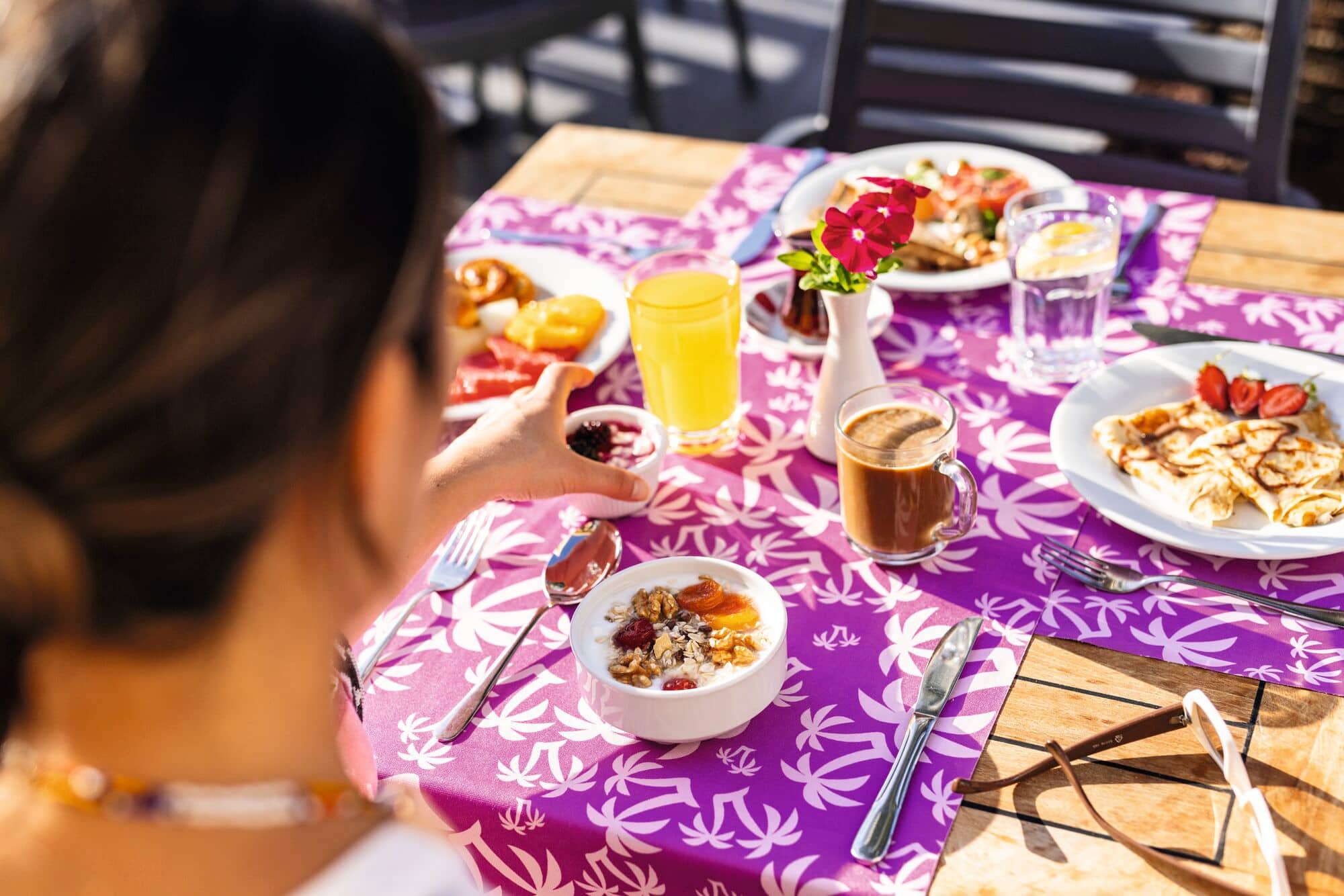 Overhead view of food arranged on a table with flowers.