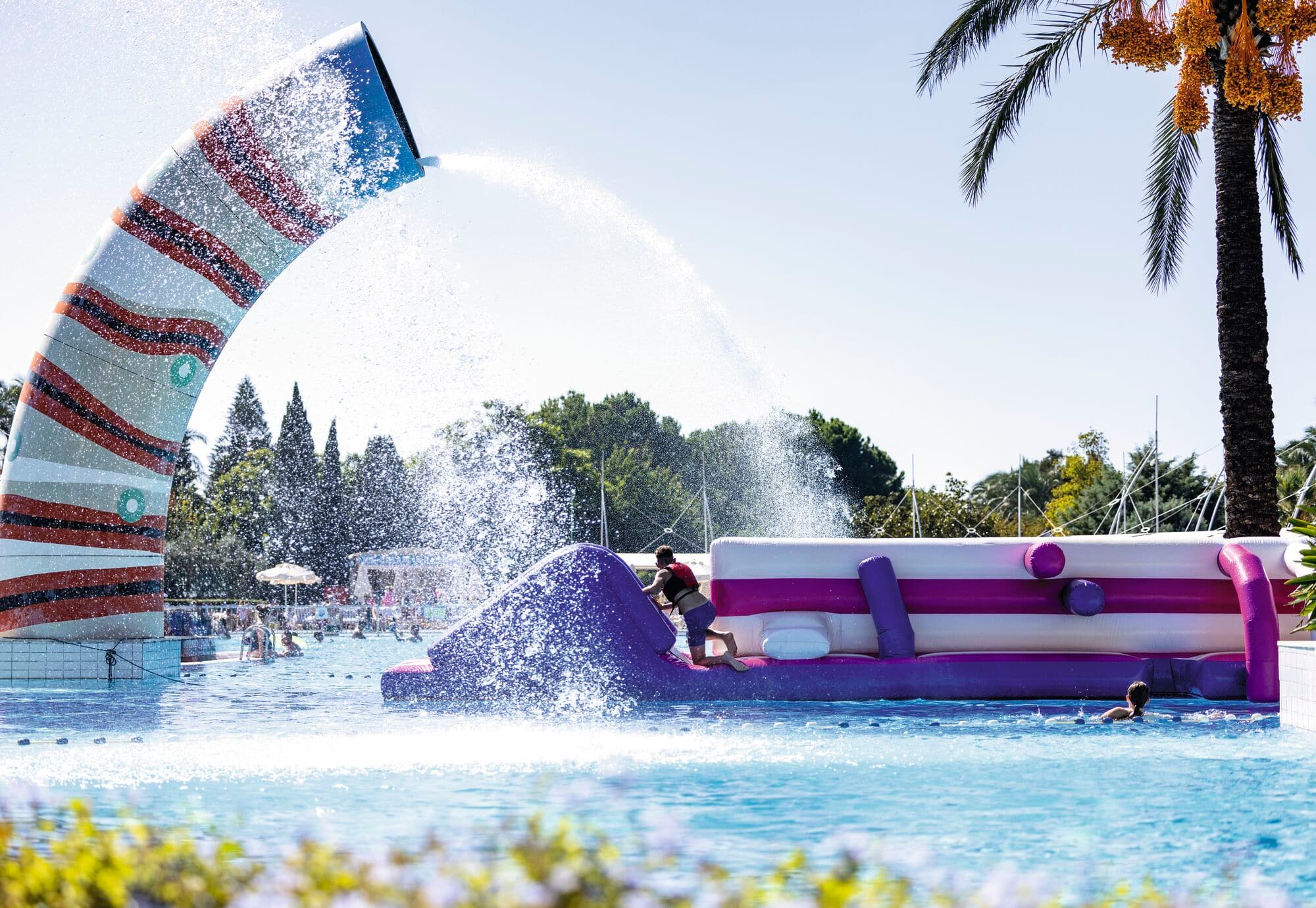 A child playing on an inflatable assault course.